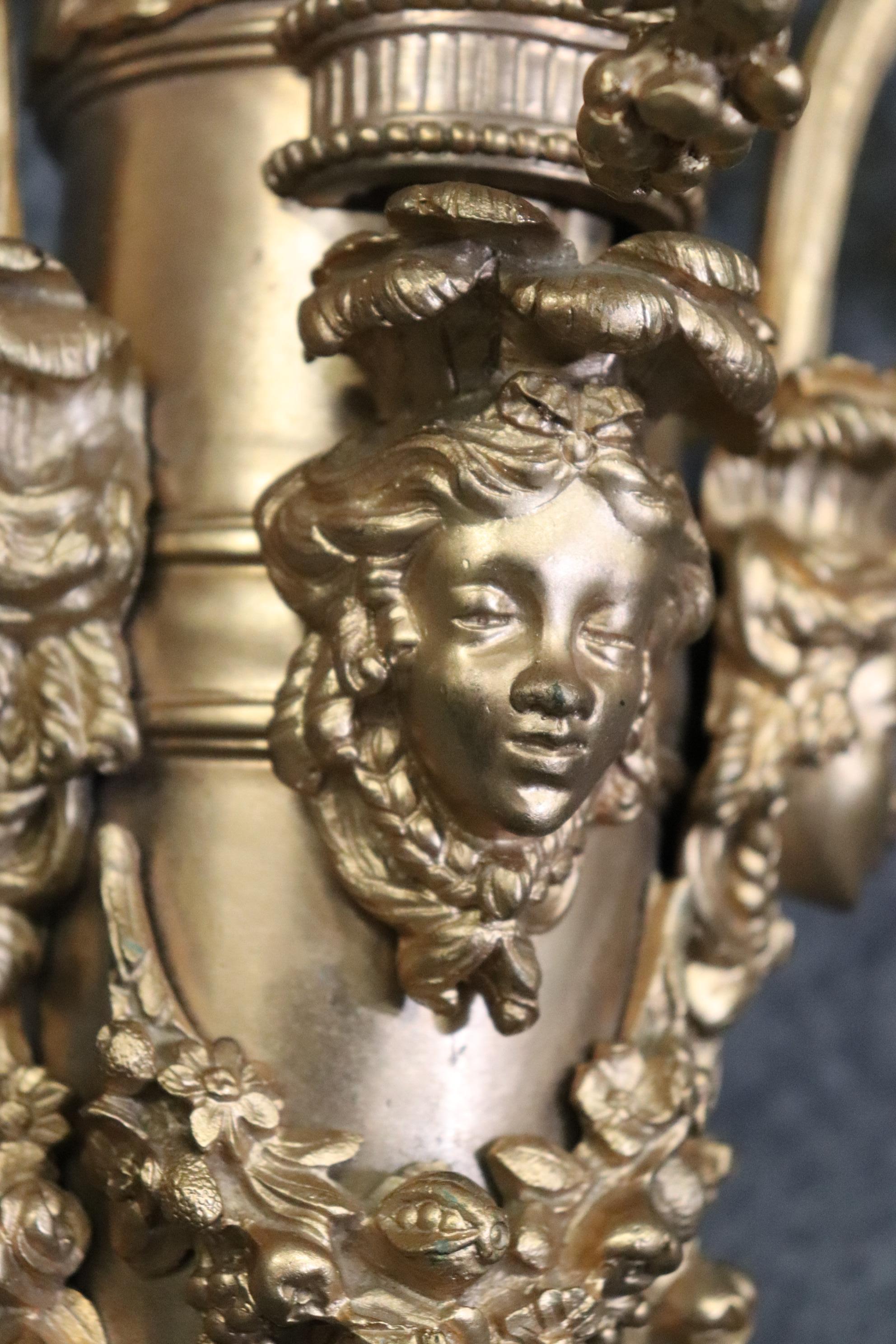 This is an outstanding figural bronze 5 light pair of sconces of huge size and incredible casting quality. The sconces are incredibly well done, the realistic foliate and figural carving is exquisite and has a nice patina. The sconces are wired and