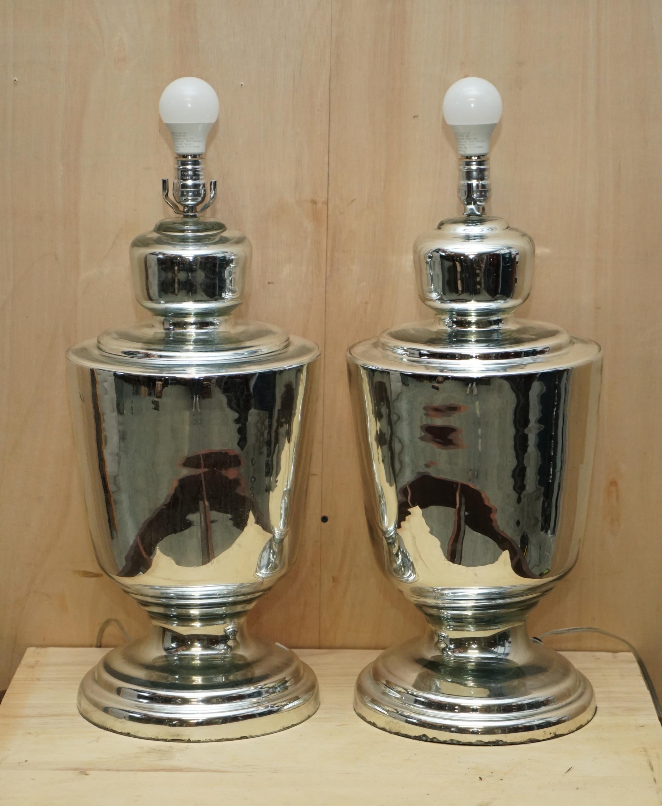 We are delighted to offer for sale this stunning pair of vintage mirrored foxed glass large urn table lamps

These lamps came from a very fine antiques dealer in Belgium, he has a client that purchases antique Italian lighting to import to the US