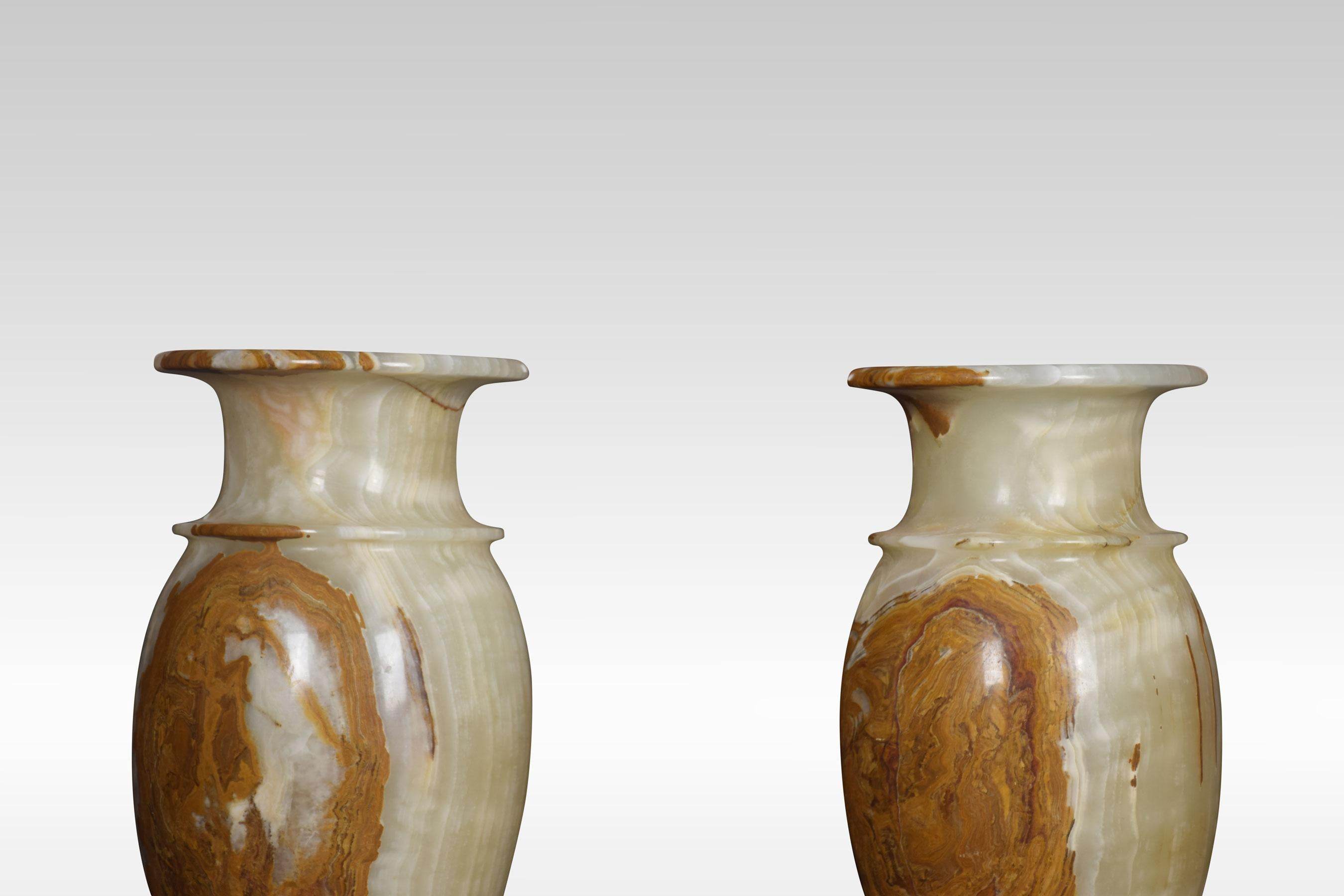 Very large pair of onyx vases, the rolling rims above slender baluster form terminating in circular bases.
Dimensions:
Height 24 inches
Width 10 inches
Depth 10 inches.