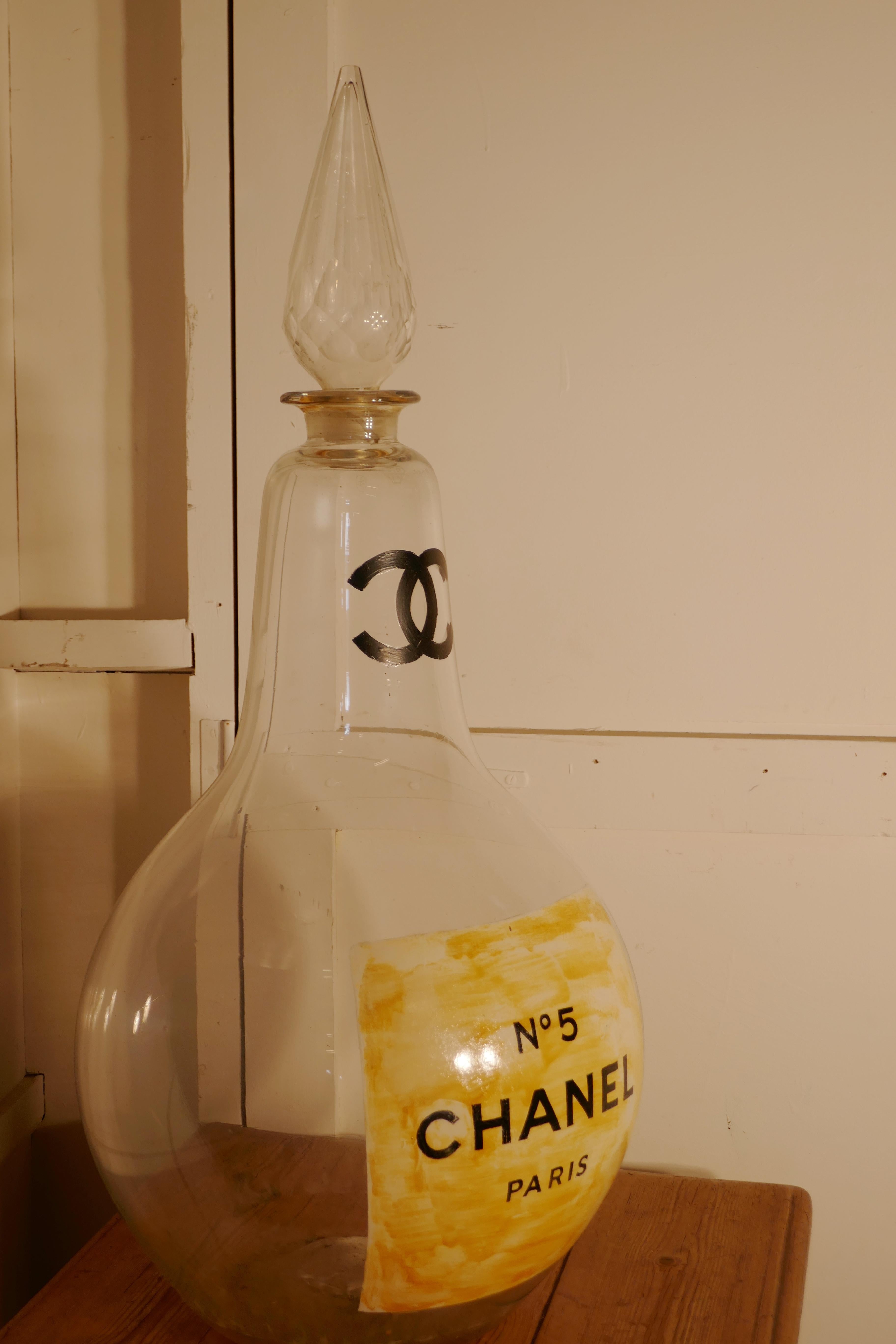 Very Large Perfume Bottle CHANEL No5 Paris

This is a very large Glass bottle with a very large faceted stopper, in this case it is advertising CHANEL No5, it was painted for an exhibition display, and from there it has been used in a perfumery 
The