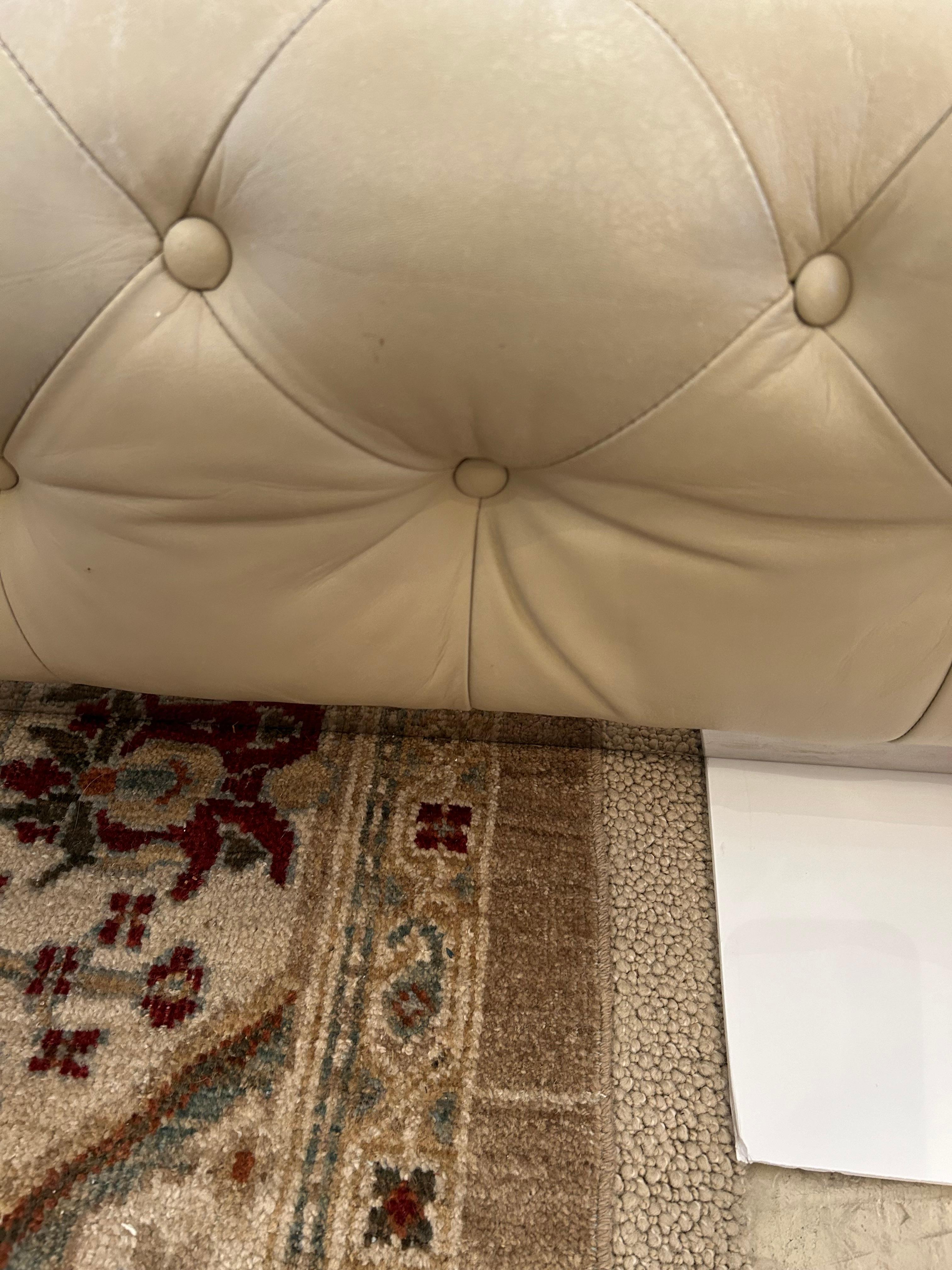 Sumptuous large square tufted leather beige ottoman on chrome base.  Could be used as a coffee table and extra seating.