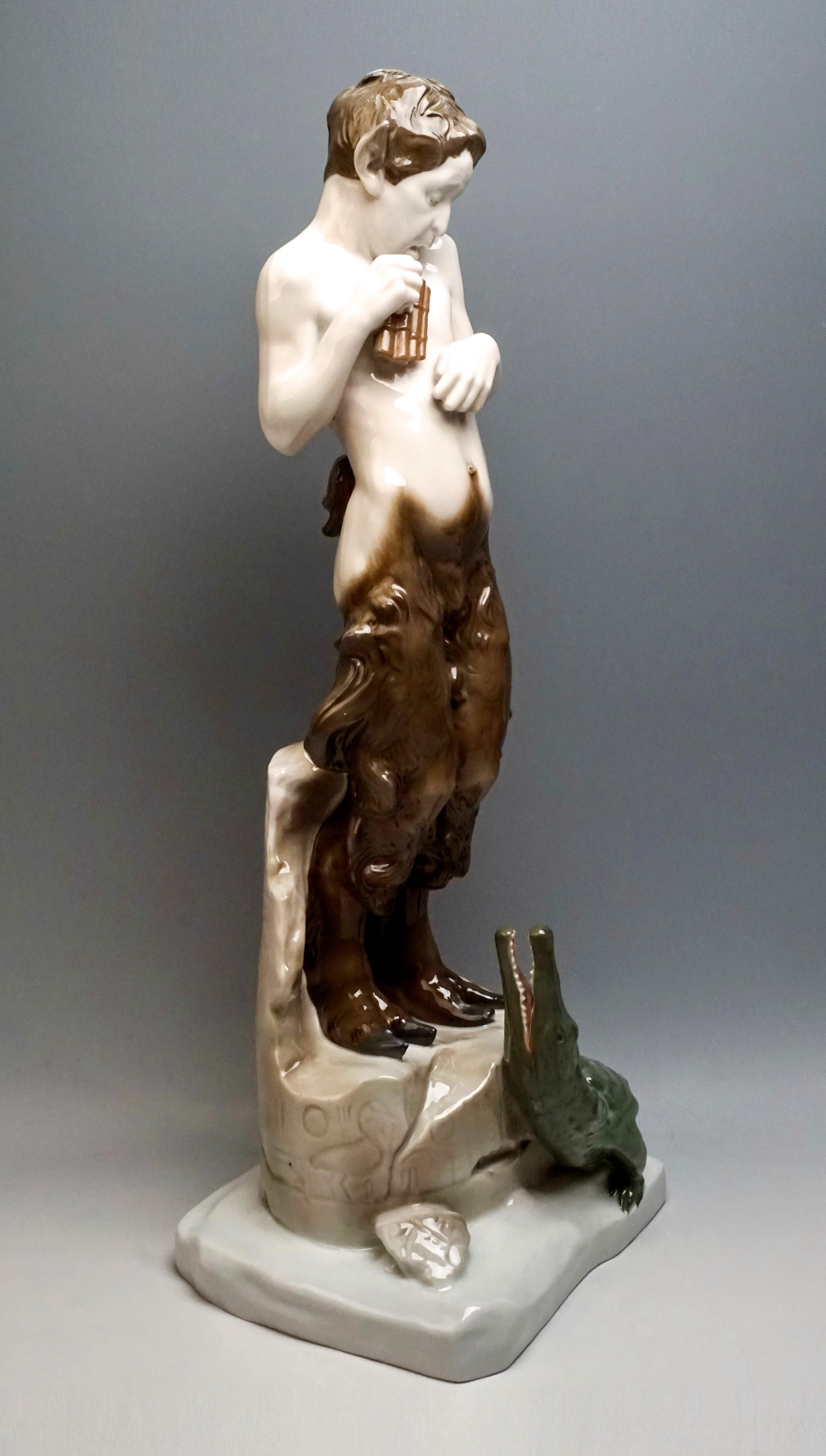 Admirable and very rare Art Nouveau Figurine by Rosenthal.
The faun stands frightened on a broken piece of ruins with Egyptian inscriptions, holding a panpipe in his right hand, a small crocodile at his feet, which looks up at him with open mouth