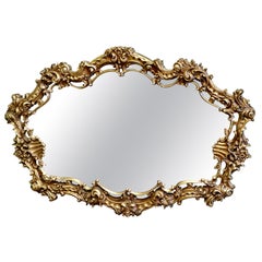 Très grand miroir mural doré de style rococo