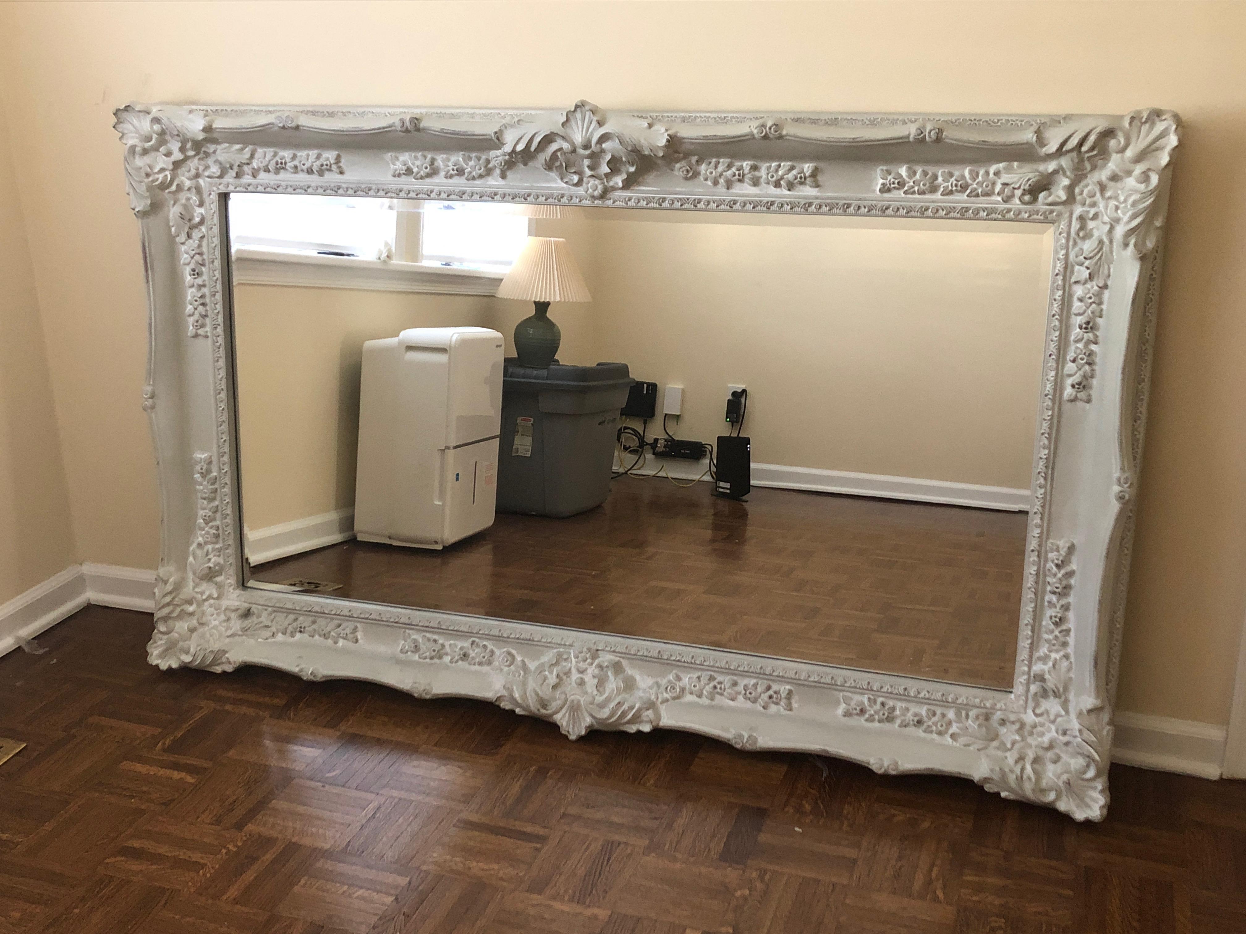 Very pretty impressively carved gray painted mirror. Mirror is beveled.