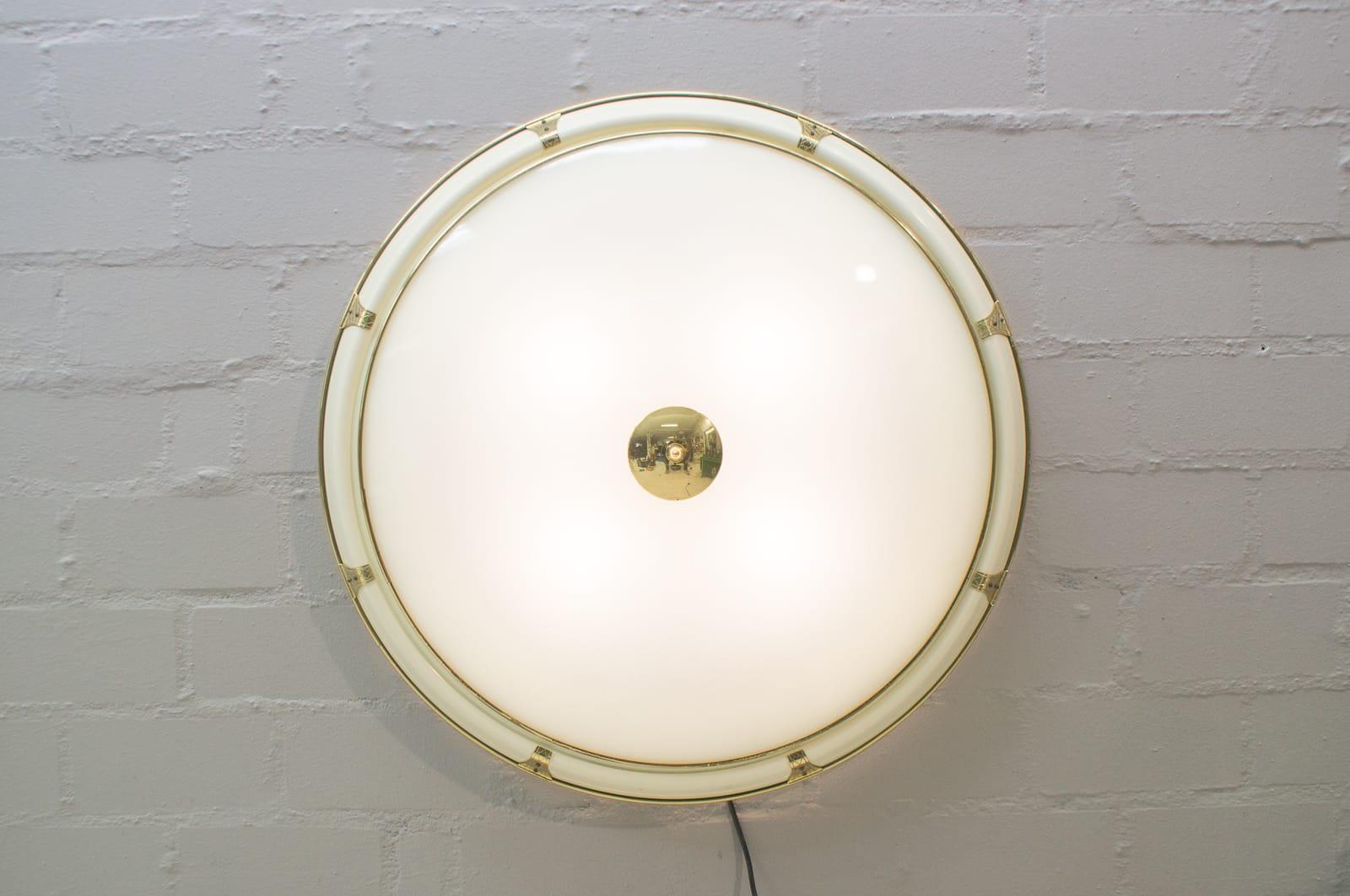 Rare and elegant Mid-Century Modern flush mount or wall lamp, 1950s, Austria. Executed in lacquered metal, brass and glass.

The lamp is executed with 4 x E27 Edison screw fit bulbs. It is wired, and in working condition. It runs both on 110 / 230