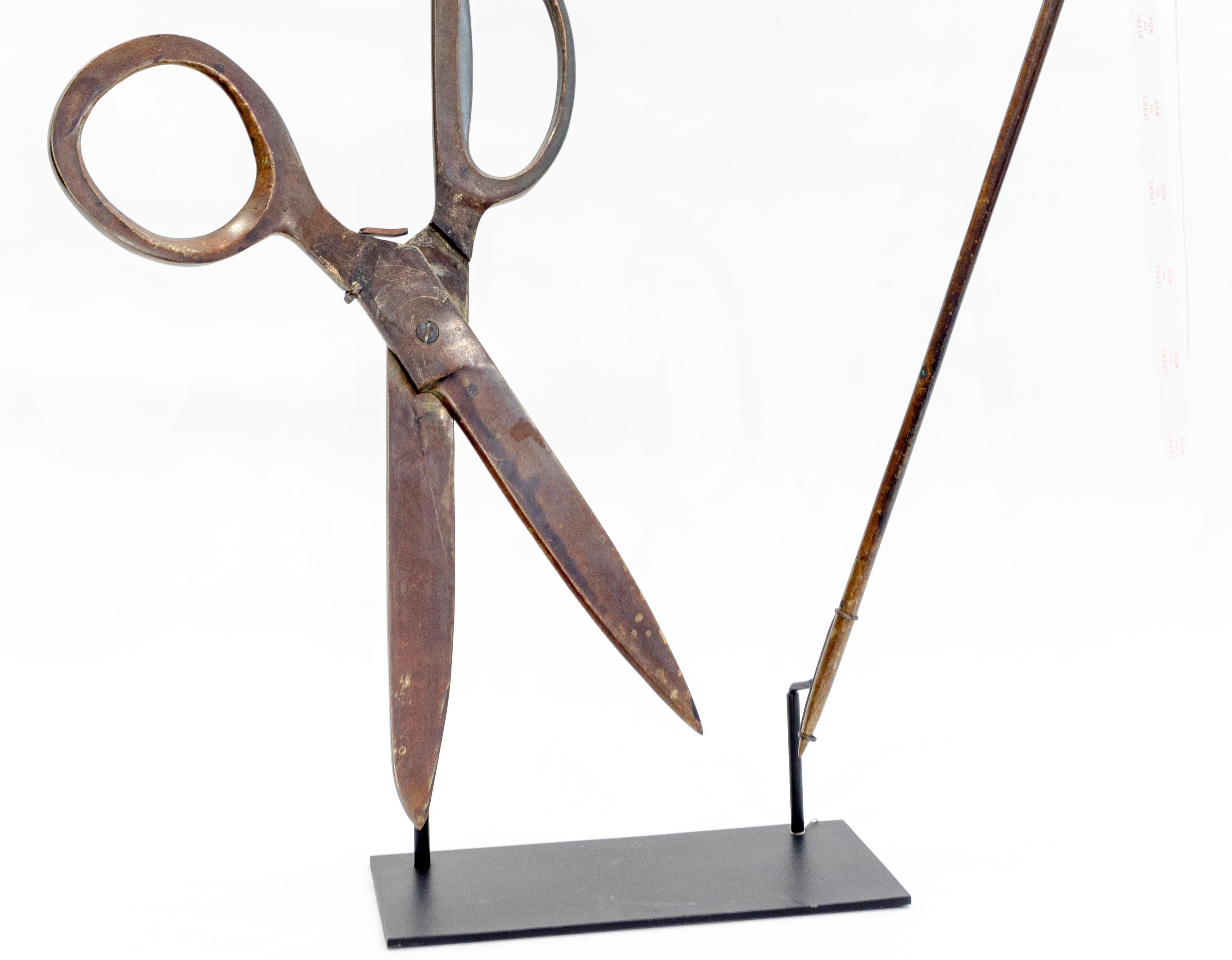 Brass scissors and needle trade sign with pivoting needle, 19th century. Measures: height 35”, length 28.5”, depth 10”.
 