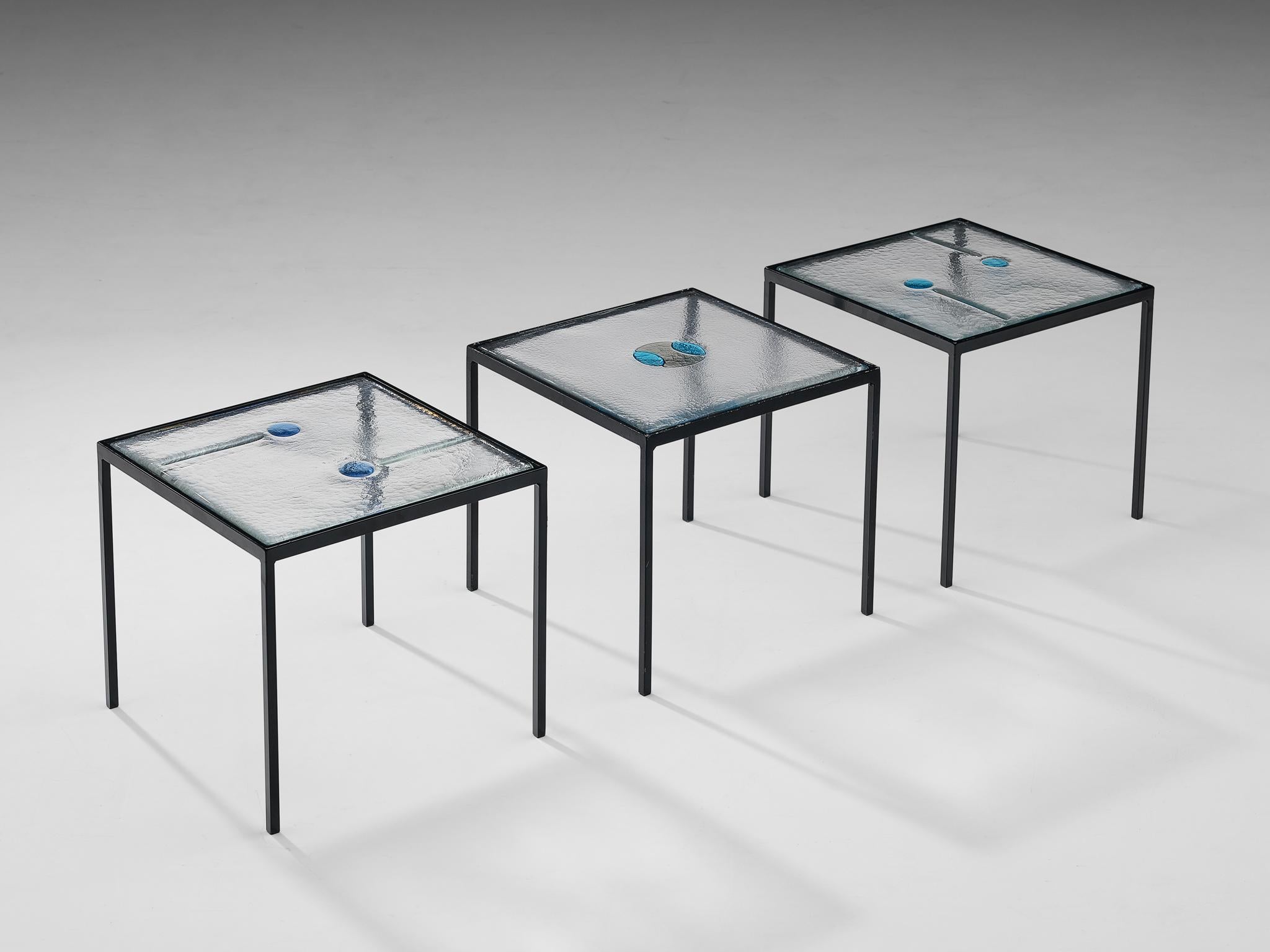 Side tables, blue, green and transparent glass, steel, Europe, 1980s

This large set of side table is both playful in its aesthetics and solid in its construction. This set of lovely tables all feature a different top of structured glass yet