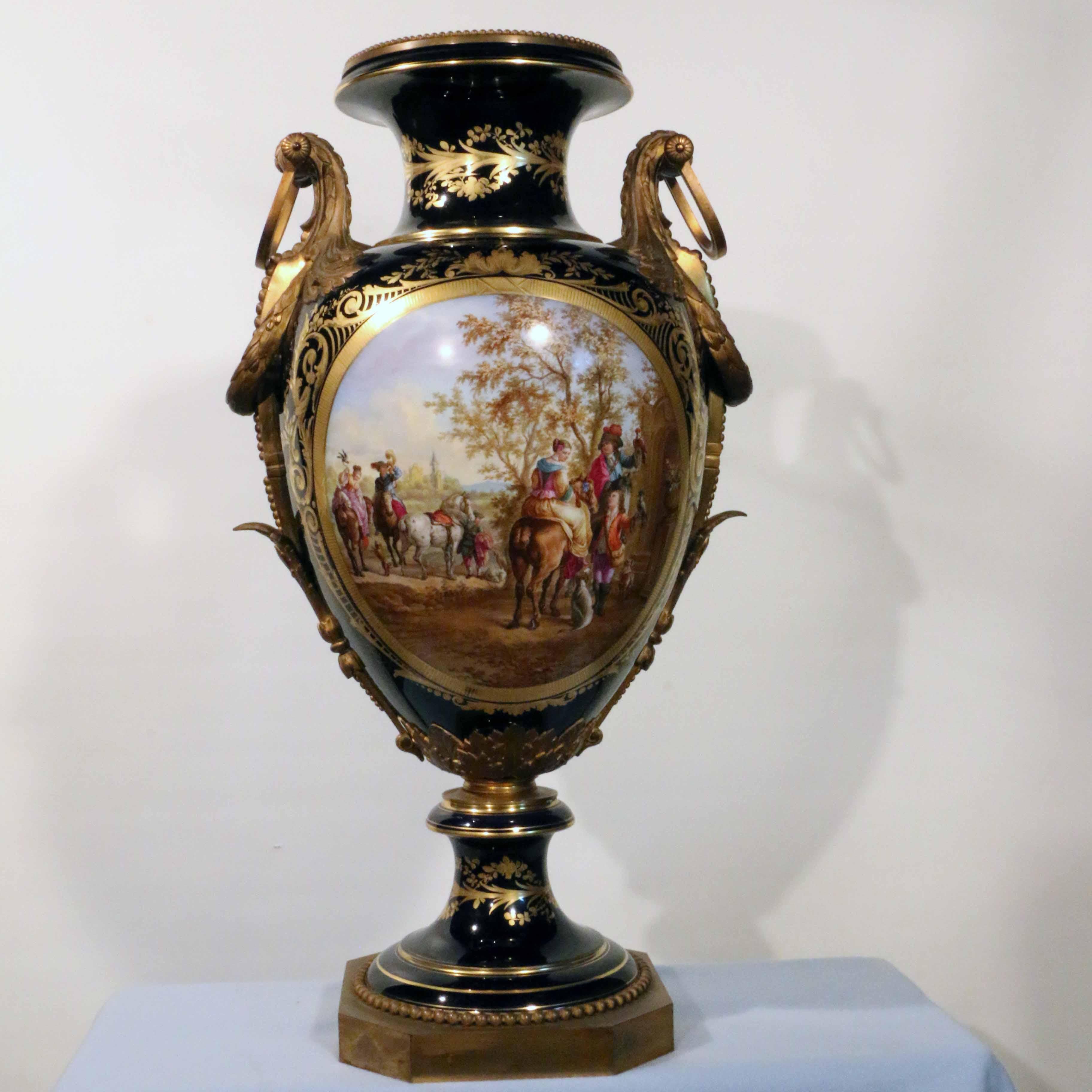 This sumptuous vase is both very large and exceptionally well-painted. The principal scene in an oval reserve is painted after Wouvermans. (This scene is rather rare and may be of interest to our Middle Eastern clients). The reserves are boldly