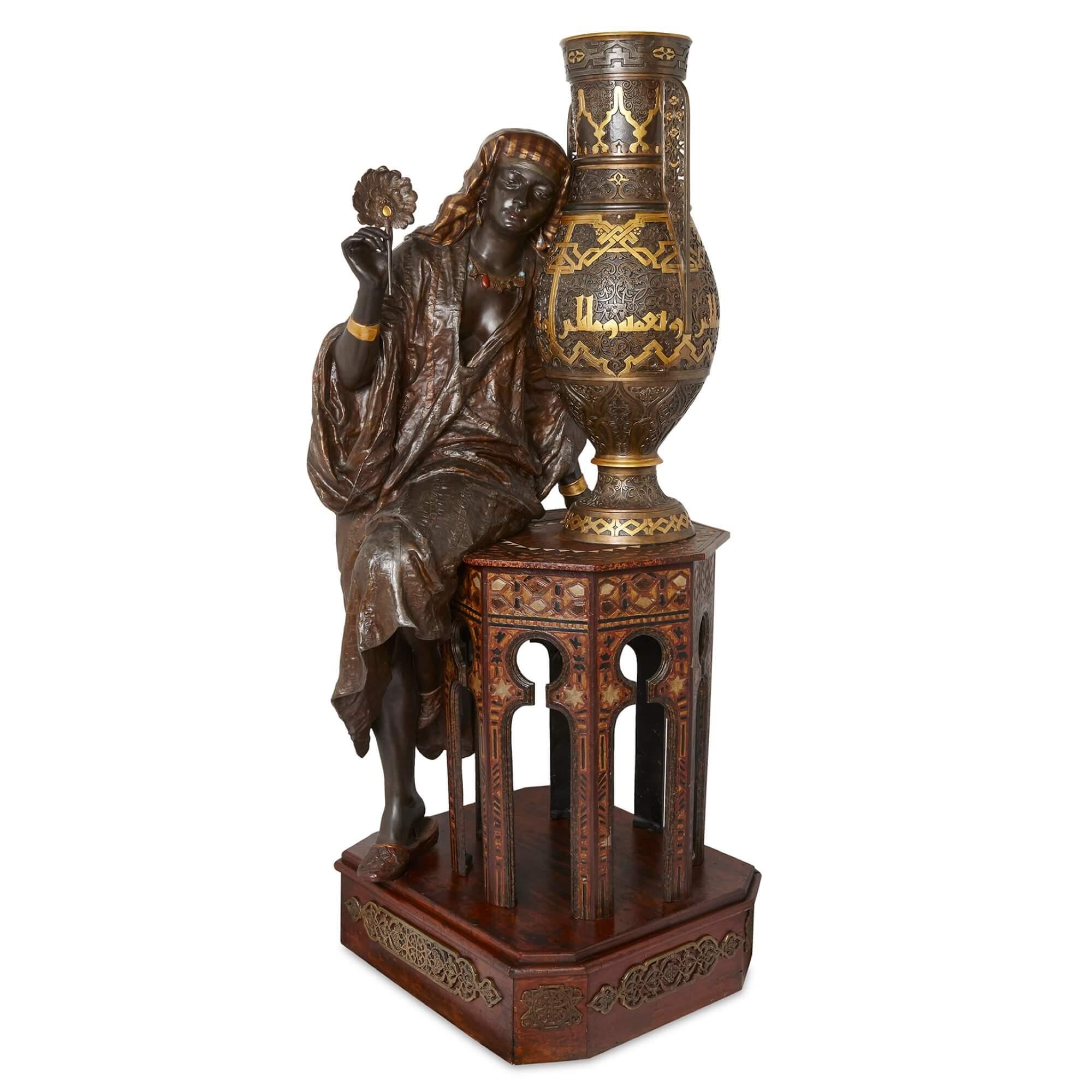 Very large spelter Orientalist sculpture attributed to Hottot
French, Late 19th Century
Height 194cm, width 84cm, depth 75cm

This sensational life-size figural group depicts a female figure leaning against a table. The woman wears a typical