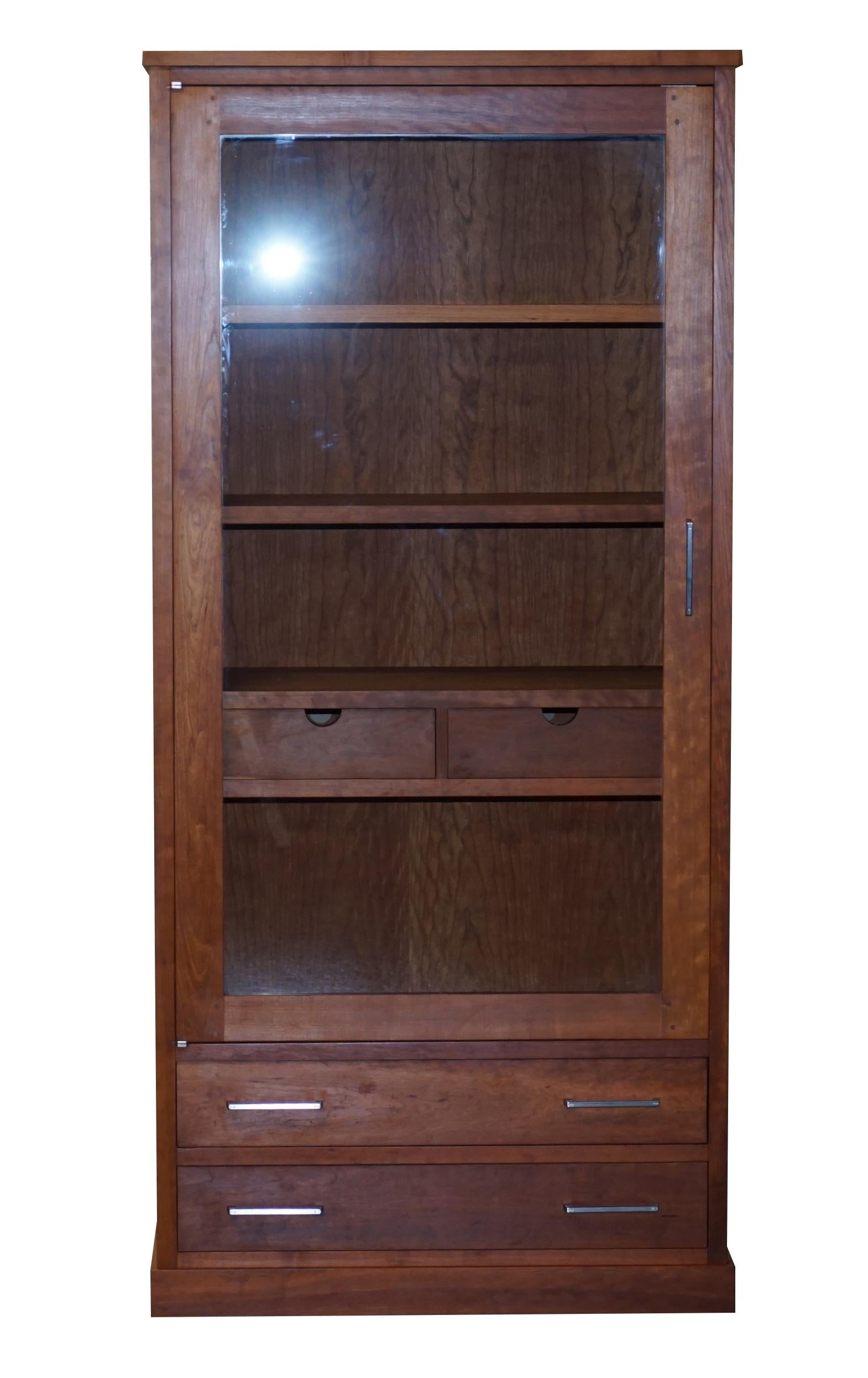 Wimbledon-Furniture is delighted to offer for sale this stunning hand made in Italy Riva 1920 solid American Black Cherry wood with large glazed door display cabinet bookcase with drawers

This is part of a suite

This is a very well made totally