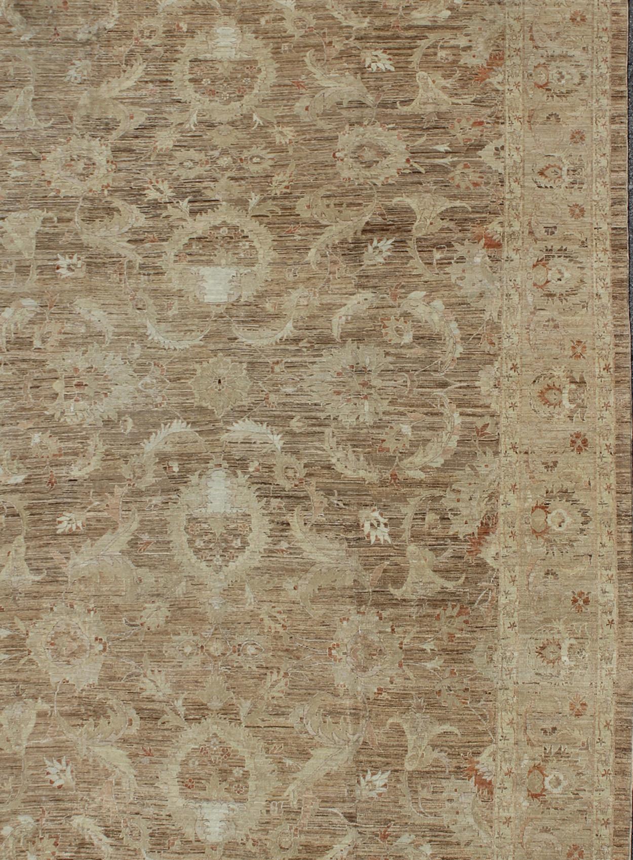 Variegated light brown, light green and earth tone Afghan made Sultanabad design rug with florals. rug, M14-0405 country of origin / type: Afghan / circa 1980.

Measures: 14'0 x 21'0

This elegantly handwoven hand woven rug is from Afghanistan