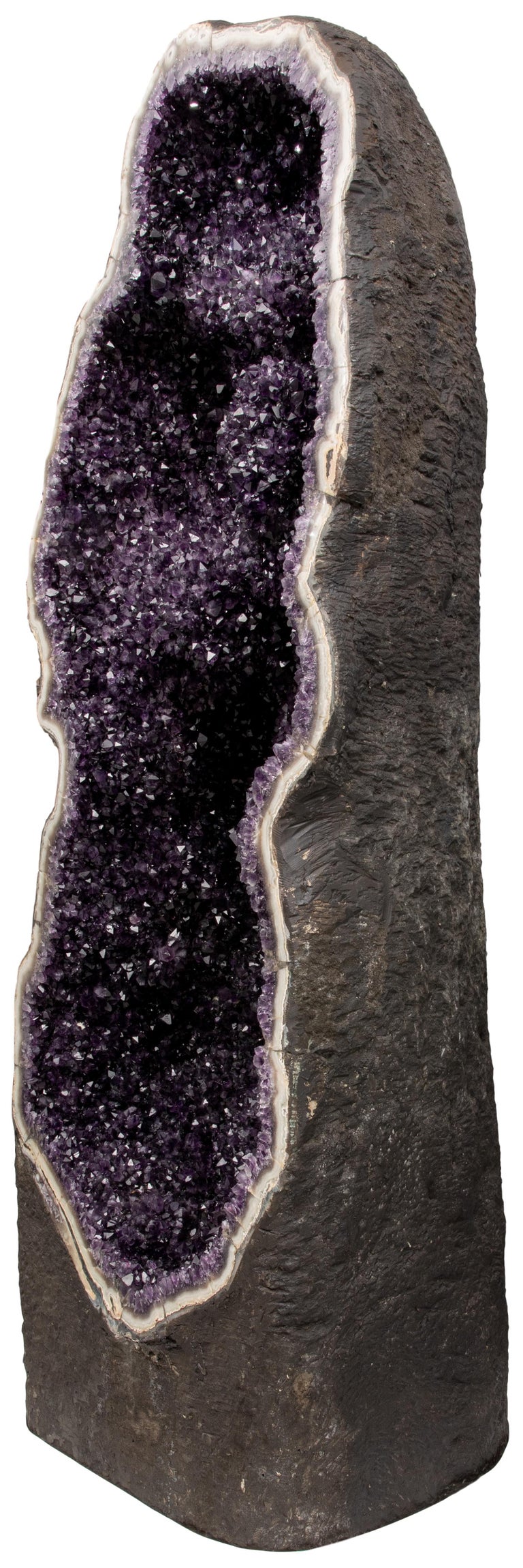 An exquisite and absolutely impressive large half geode, resembling a towering crystal column. 

This breath-taking piece represents one of the most exclusive amethyst formations to be presented for sale. Evoking a sense of elegant grandeur, the