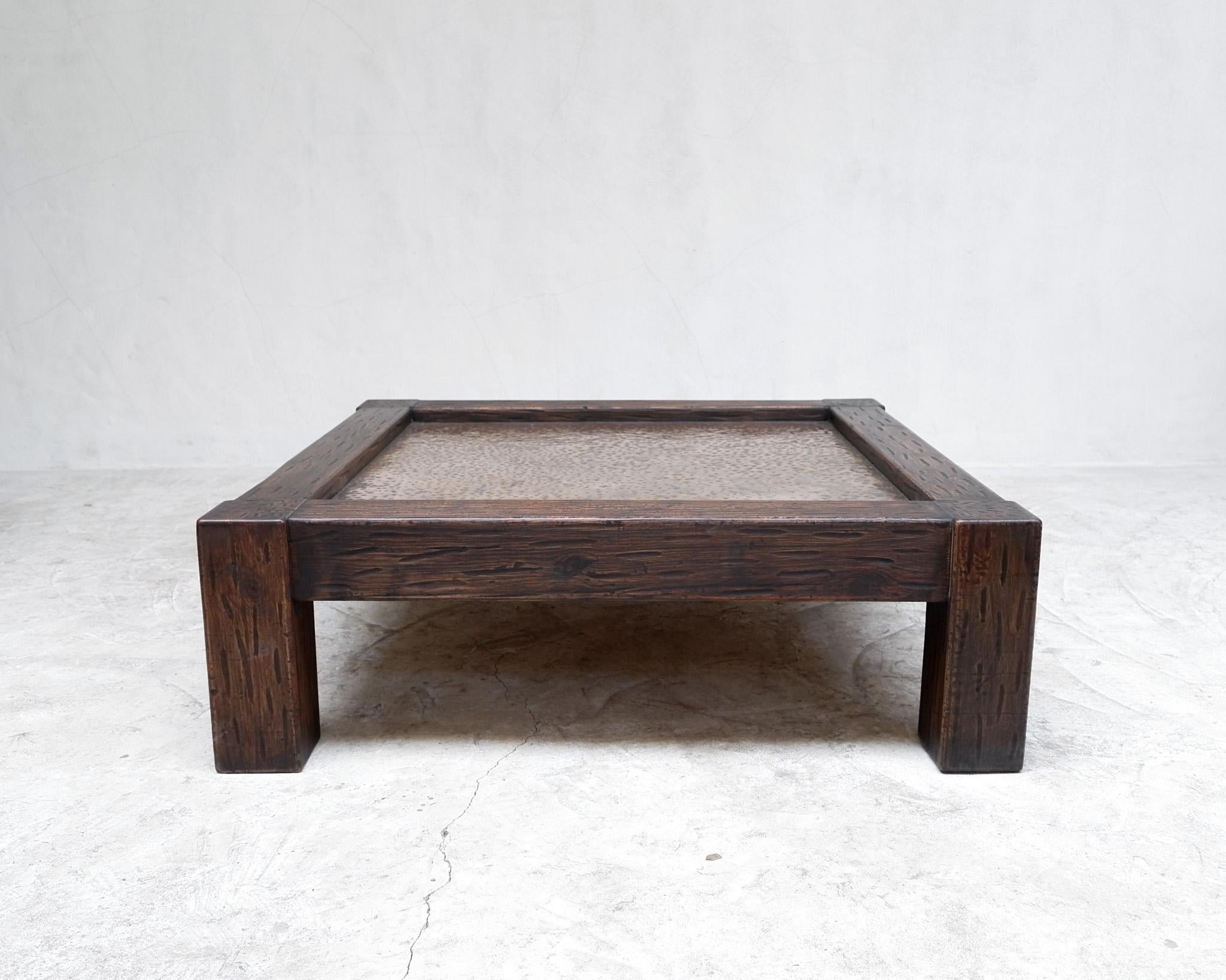 A large hewn pine coffee table with hammered copper insert. 

Spain 1970s.

-

We offer free shipping to the USA/Canada through Fedex with this item.