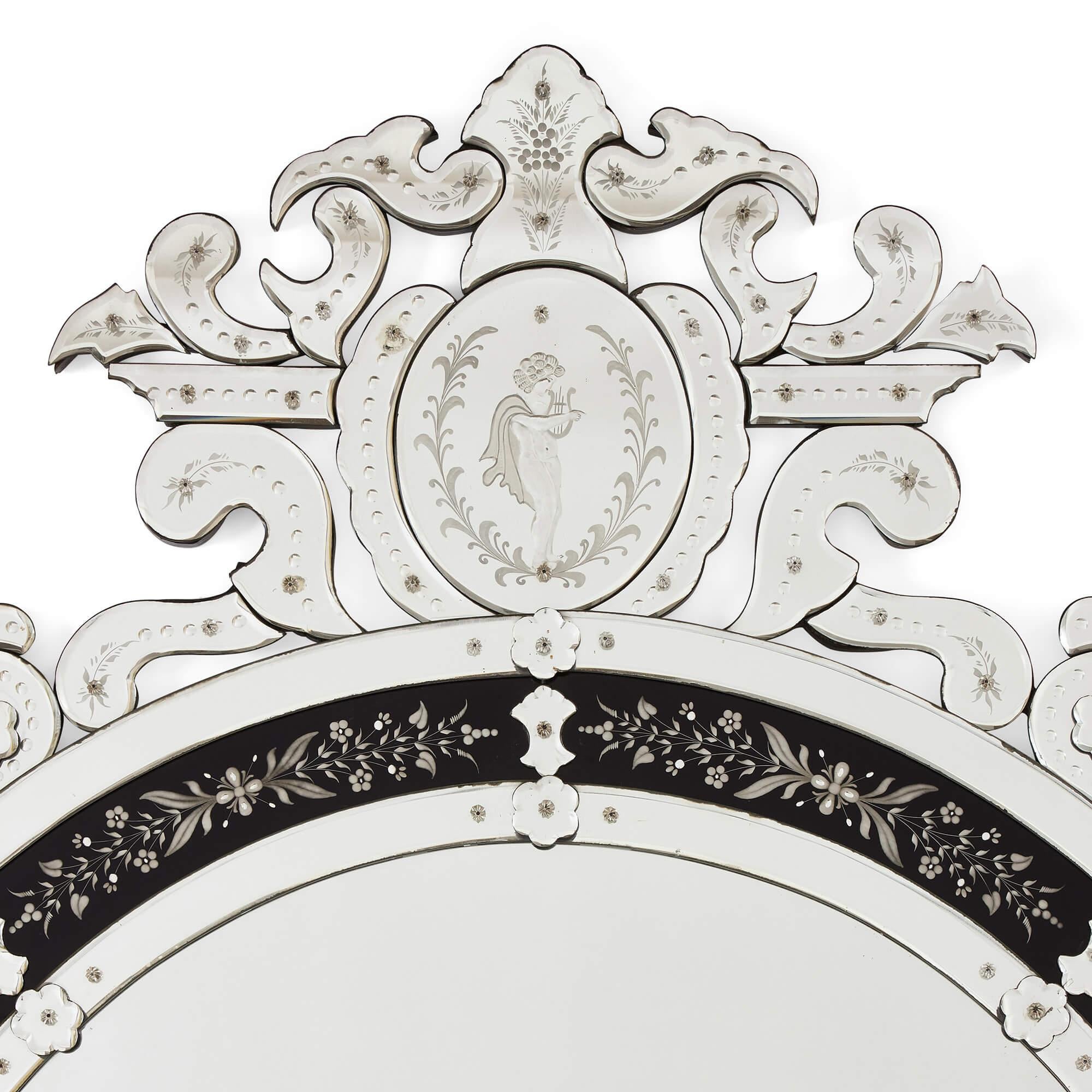 Very large Venetian glass mirror with engraved decoration
Italian, 20th Century
Height 220cm, width 124cm, depth 4cm

This monumental Venetian glass mirror boasts impressive detailing on both the crest and tail which hug the central oval, creating a
