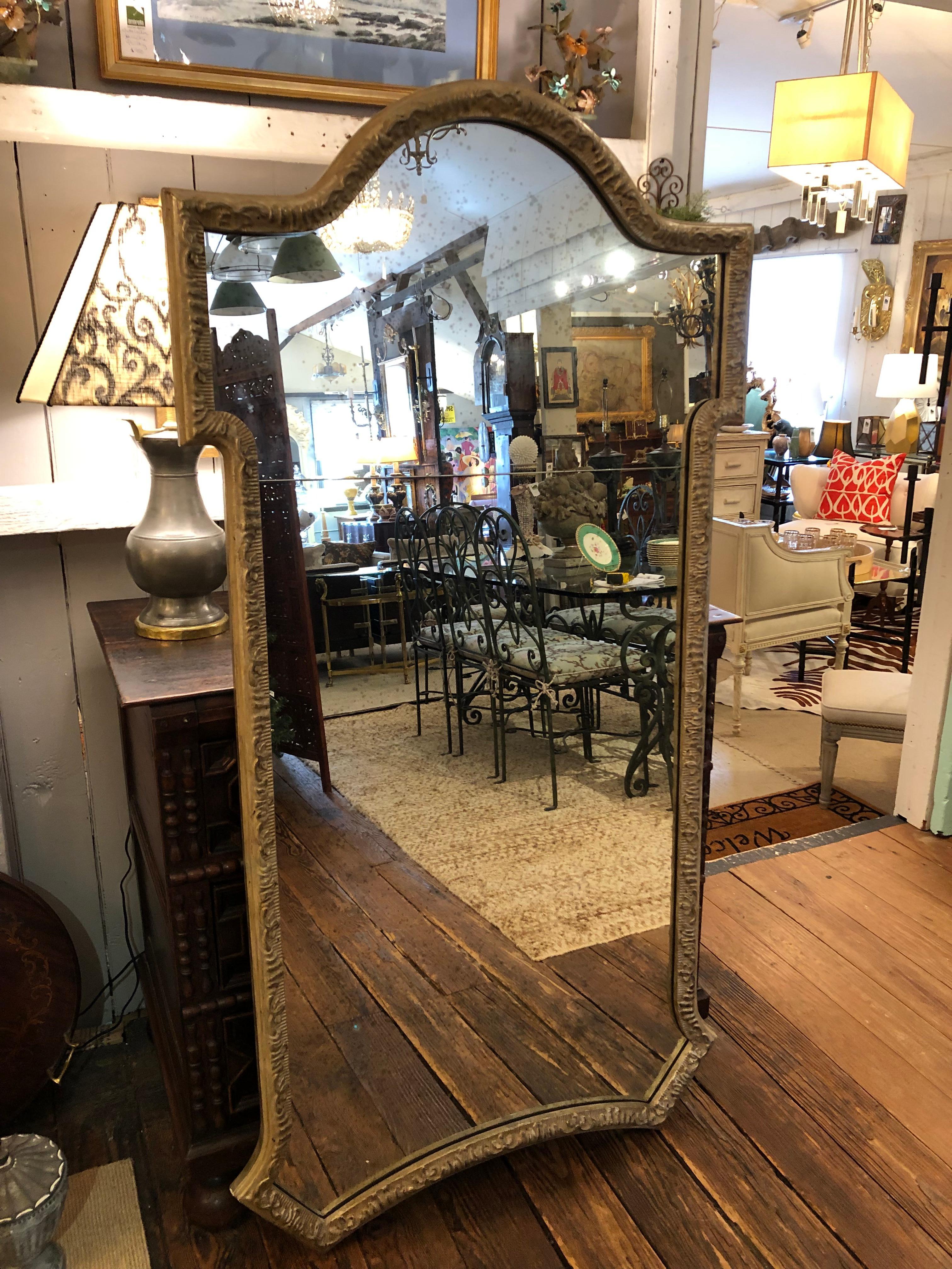 A very tall full length key hole shaped vertical silver gilt carved wood 19th century mirror having aged bevelled mirror and the classic antique two piece mirror with seam about 1/4 of the way down from the top.