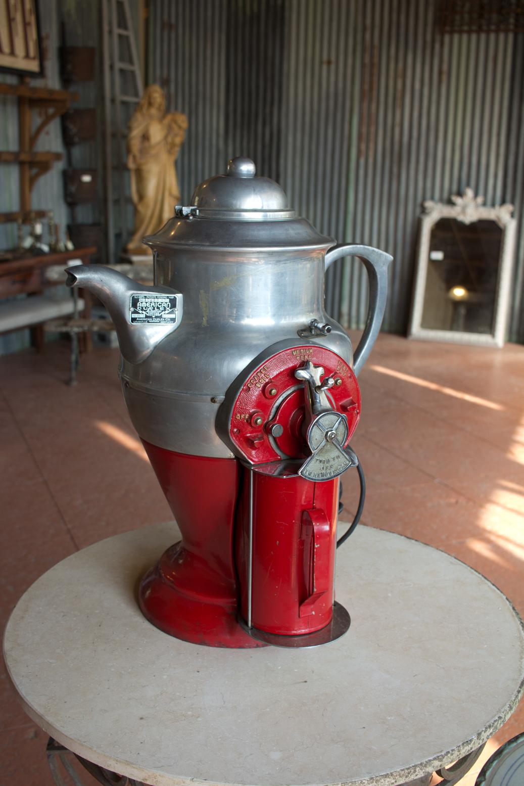Wonderful 1930s iron and chrome commercial coffee grinder in the shape of a coffee pot, by American Duplex Co. from Louisville, Kentucky. Original red paint.