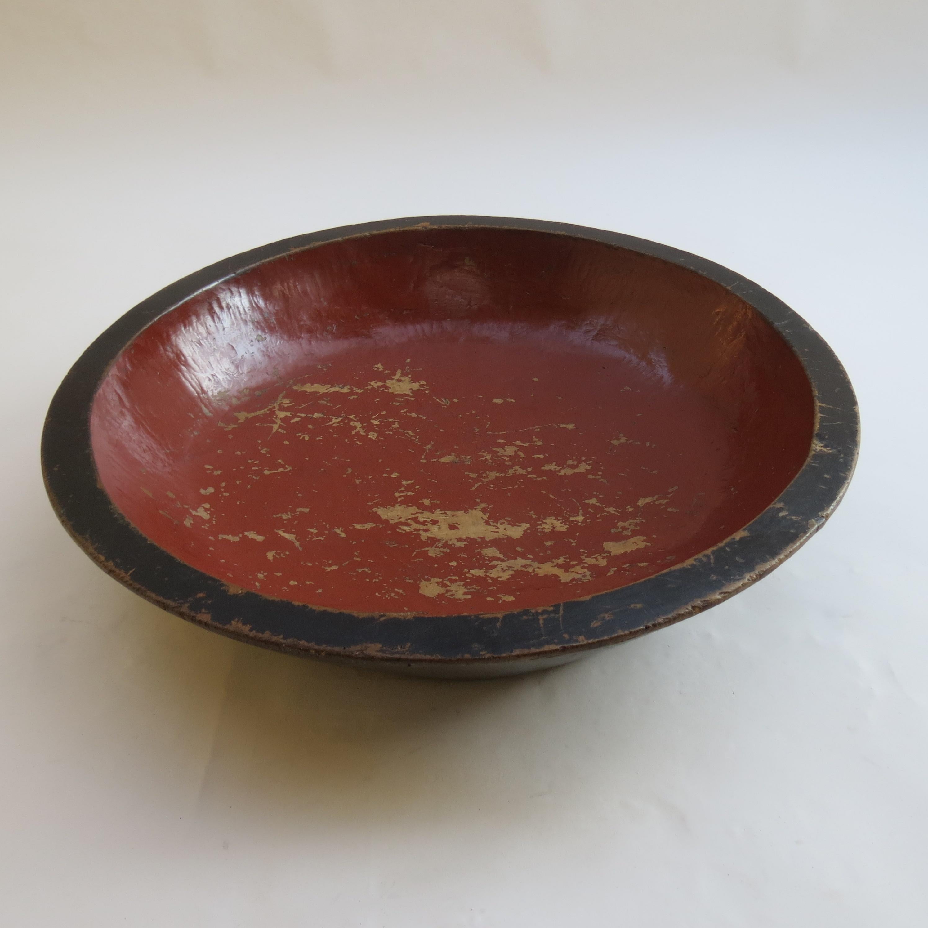 Very large vintage bowl originally from Japan. Hand produced in fruitwood, it has black lacquer to the outside and red lacquer to the inside. The finish is patinated and distressed giving a wonderful worn effect. The bowl dates from early 20th