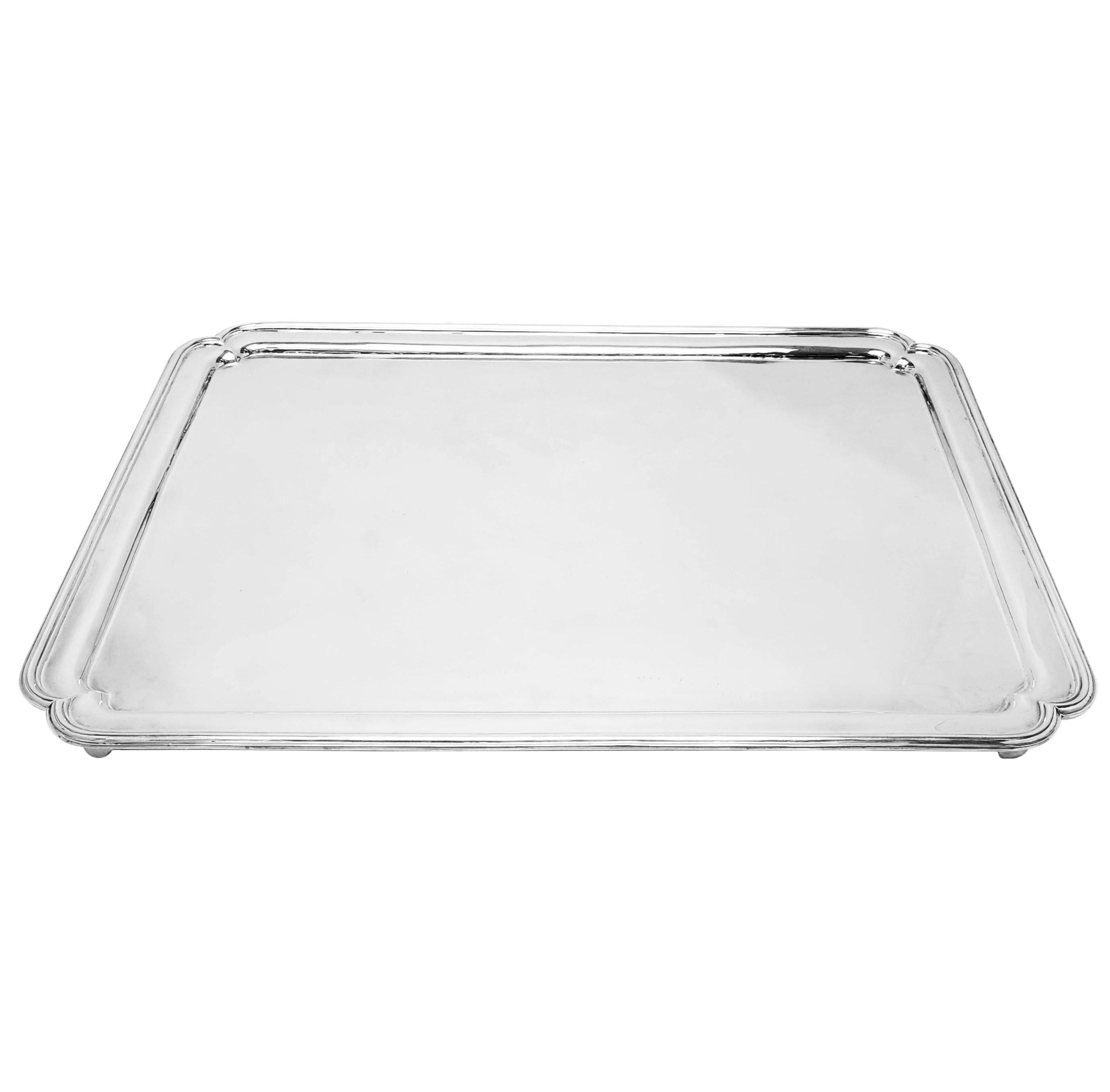 A magnificent vintage rectangular Sterling Silver Tray with shaped corners and standing on 4 raised feet. This Silver Salver is of rather monumental proportions and is a perfect statement piece.


Made in London in 1933 for Harrods (Richard Woodman