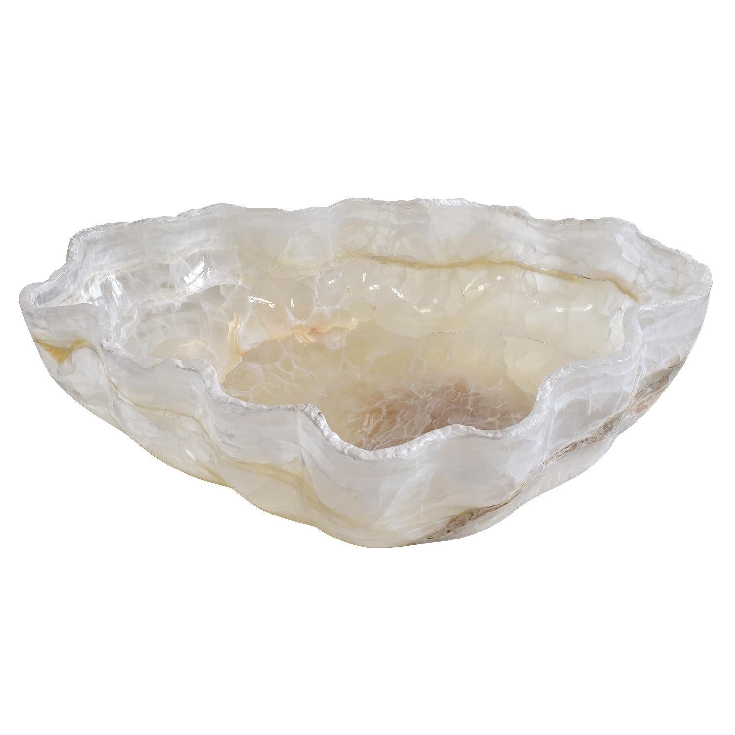 Handmade in Mexico
One solid piece of onyx
One of a kind
Dimensions: 21.5 x 20.25 w x 6.5 h in. / 55 x 51 x 16.5 cm

A spectacular, organic, undulating vessel of white to cream transparent stone with natural veining and inclusions. The deep