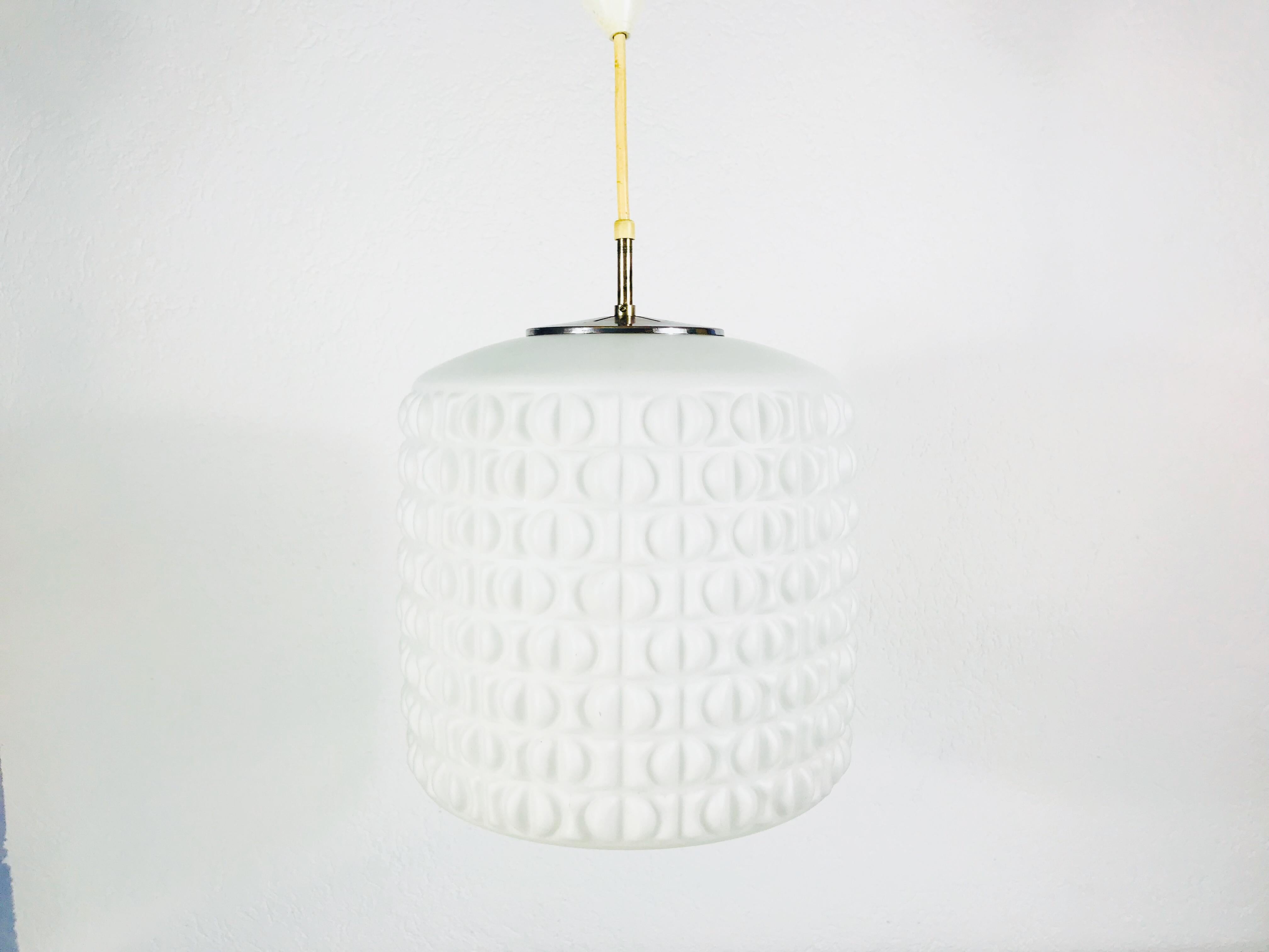 A Peill and Putzler hanging lamp made in Germany in the 1970s. It is fascinating with its glass ornaments. Textured opaline glass with aluminum top. The lamp has a beautiful cylinder shape.

The light requires one E27 light bulb.