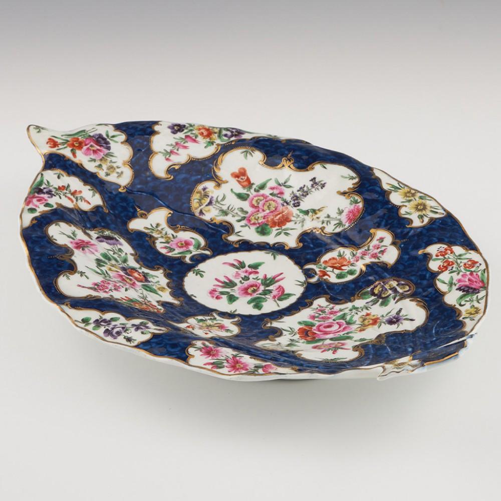 Heading : Worcester blue scale leaf dish
Date : c1775
Period : George III
Marks : Worcester pseudo fret square
Origin : Worcester, England  
Colour : Polychrome, blue ground
Pattern : Blue scale with floral panels 

Features: Gilt bordered mirror