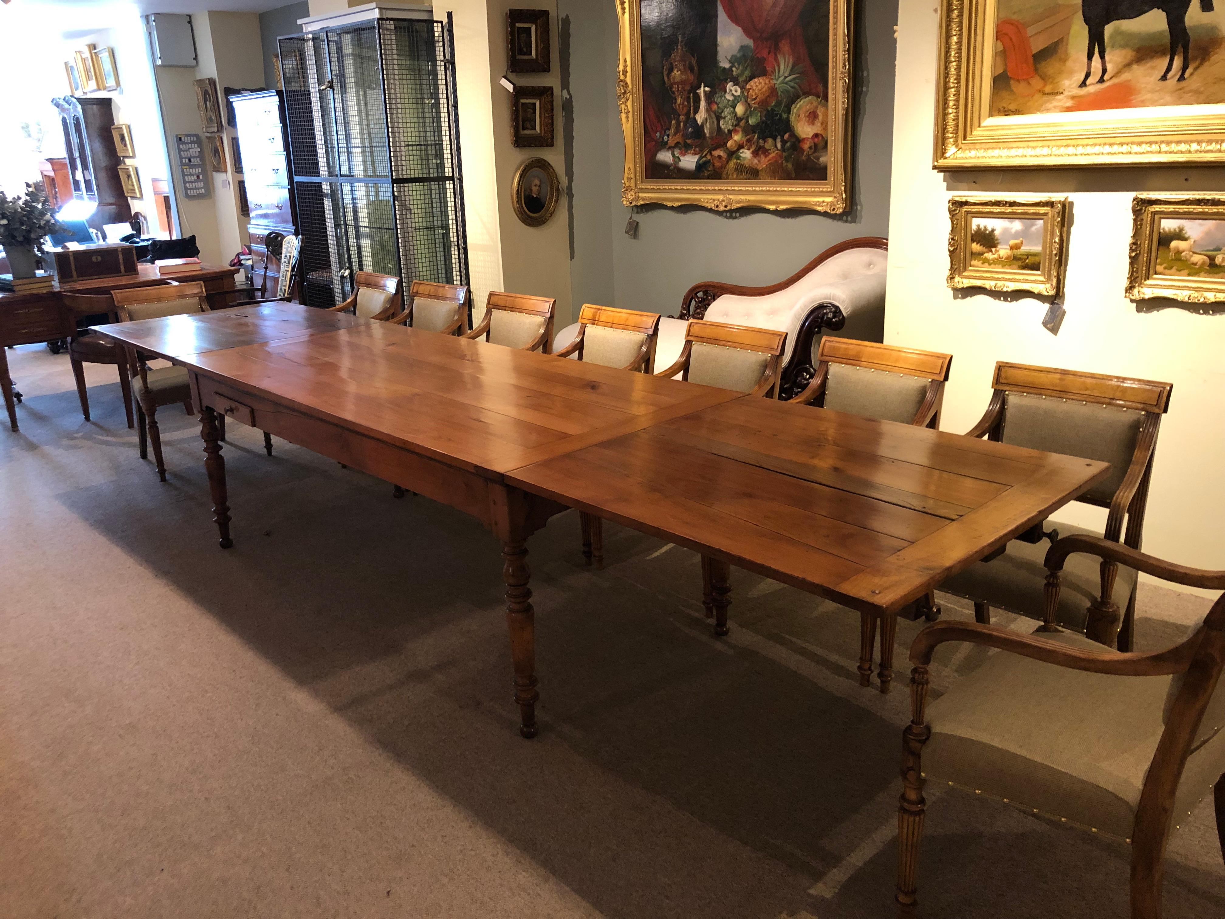An exceptional quality early 19th century french cherrywood double extending farmhouse dining table with beautifully turned legs typical of the charles x period. This table has been restored to the highest standard. The leaves easily slide out from