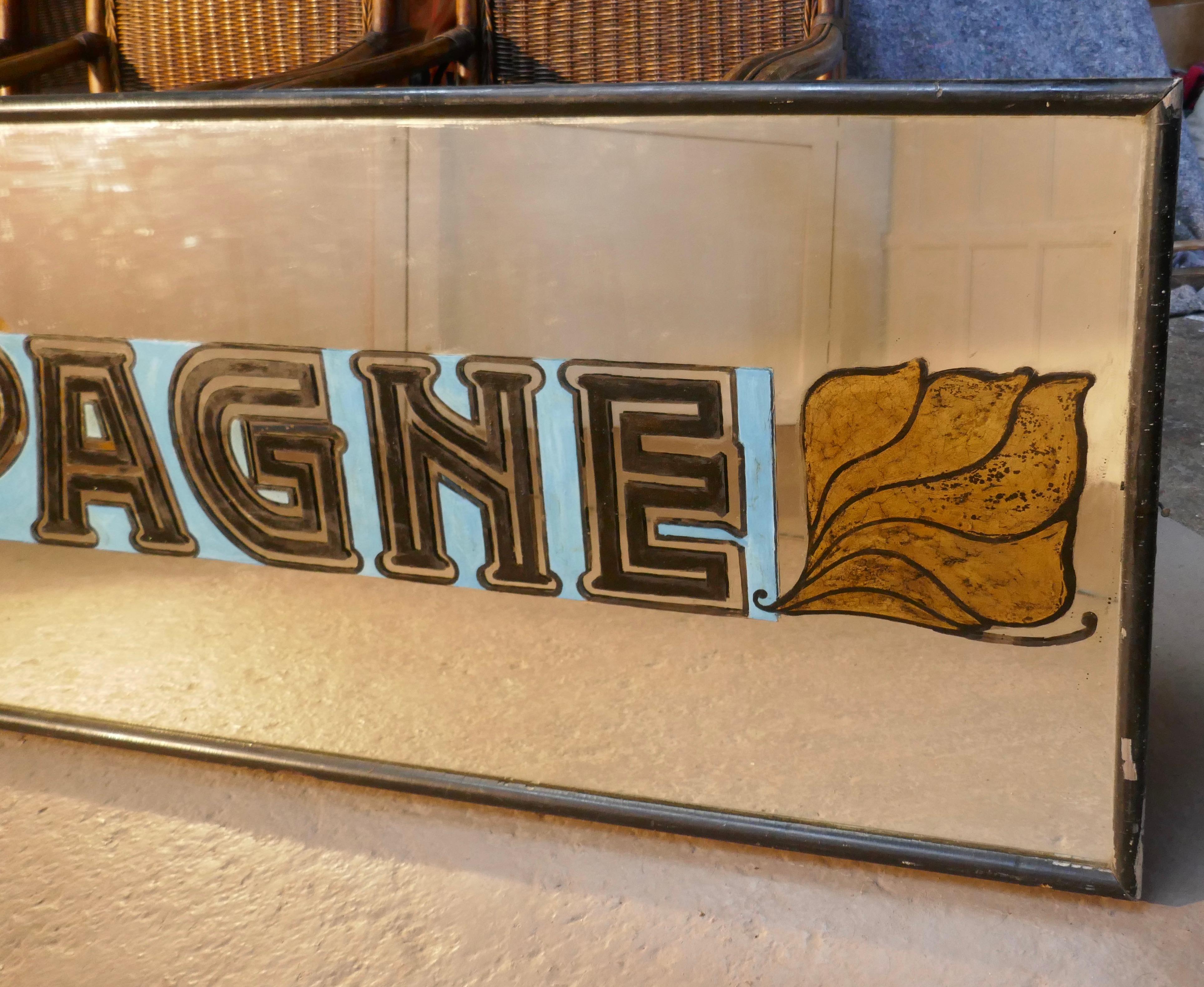 Very long Art Deco champagne wine bar wall mirror, original Frame

The mirror has “Champagne” with the vineyard leaf logos at each end painted in silver and black Art Deco lettering, it has a plain D shaped 2” frame
The looking glass is in good