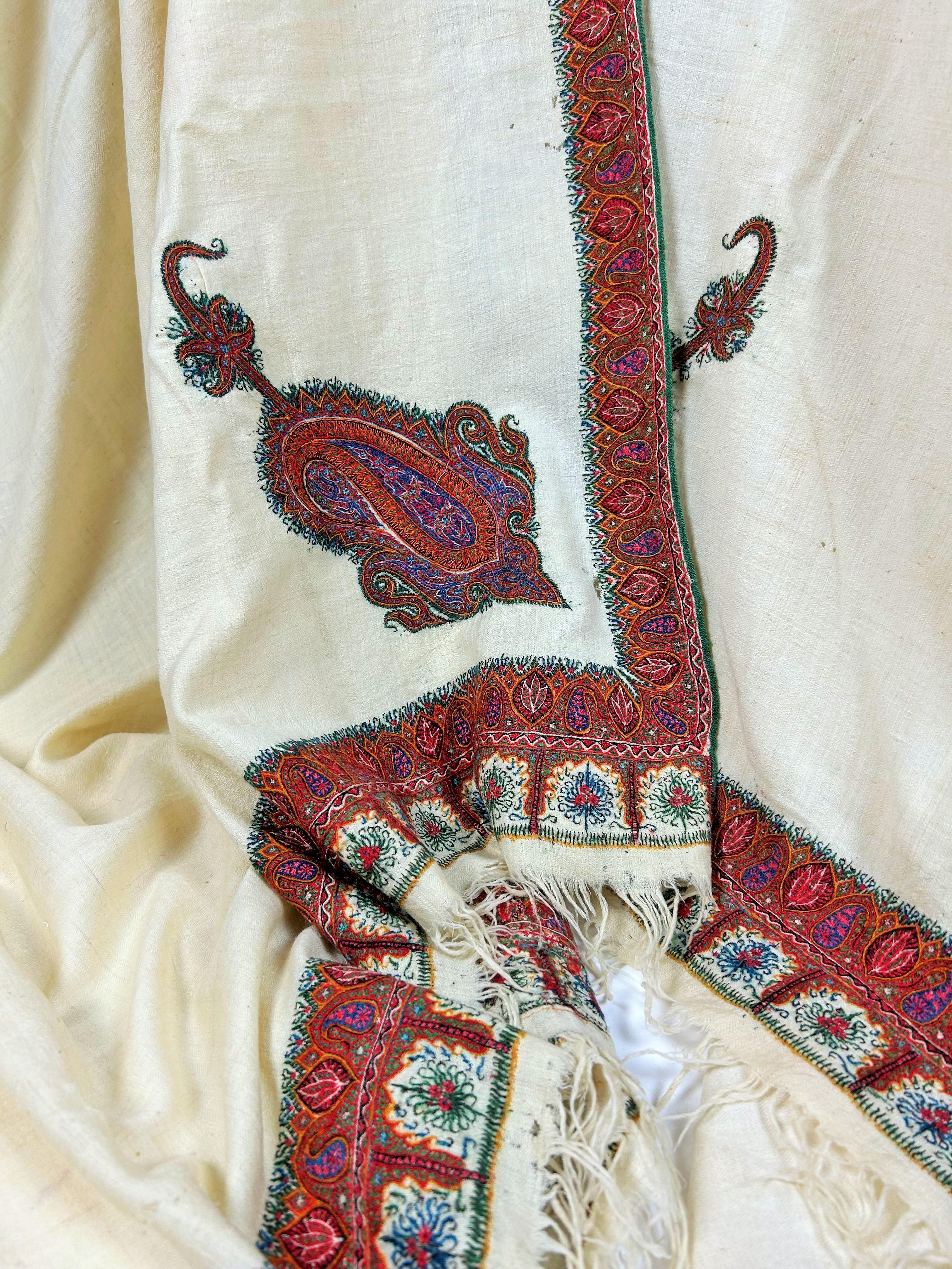 Circa 1880
India for the domestic market or Persia

Very long embroidered shawl on a cream pashmina background known as Amlikar. Large reserve of very fine Tibetan goat's down, very tightly woven in herringbone twill. Framed by fine polychrome wool
