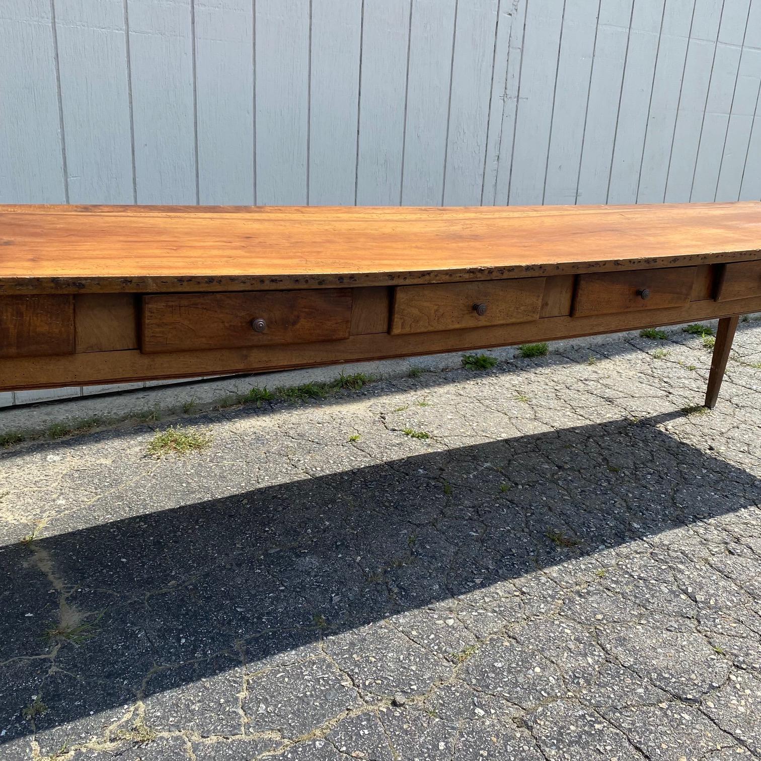This 9 and 1/2 foot long walnut table was found in Avignon and originates from a monastery in France.   Lovely, long and not too wide, it boasts six deep drawers and unbelieveable character.  Slight sway in center, but doesn't effect tableware or