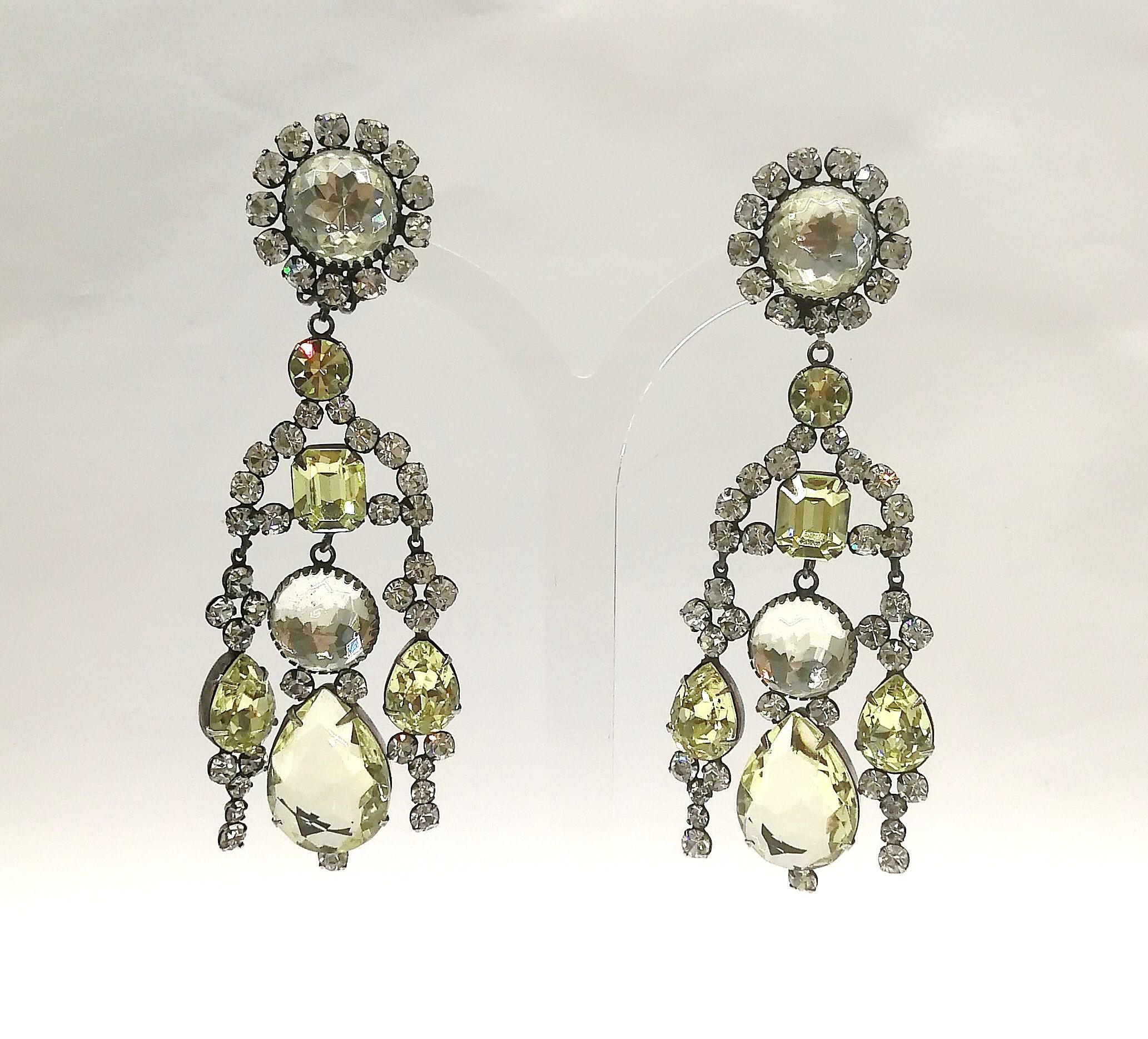 These truly stunning earrings from the early creations of Kenneth Jay Lane in the 1960s, detail an unusual and sophisticated colour combination of clear and pale citrine pastes of varying cuts and sizes, set in an antiqued silvered metal.