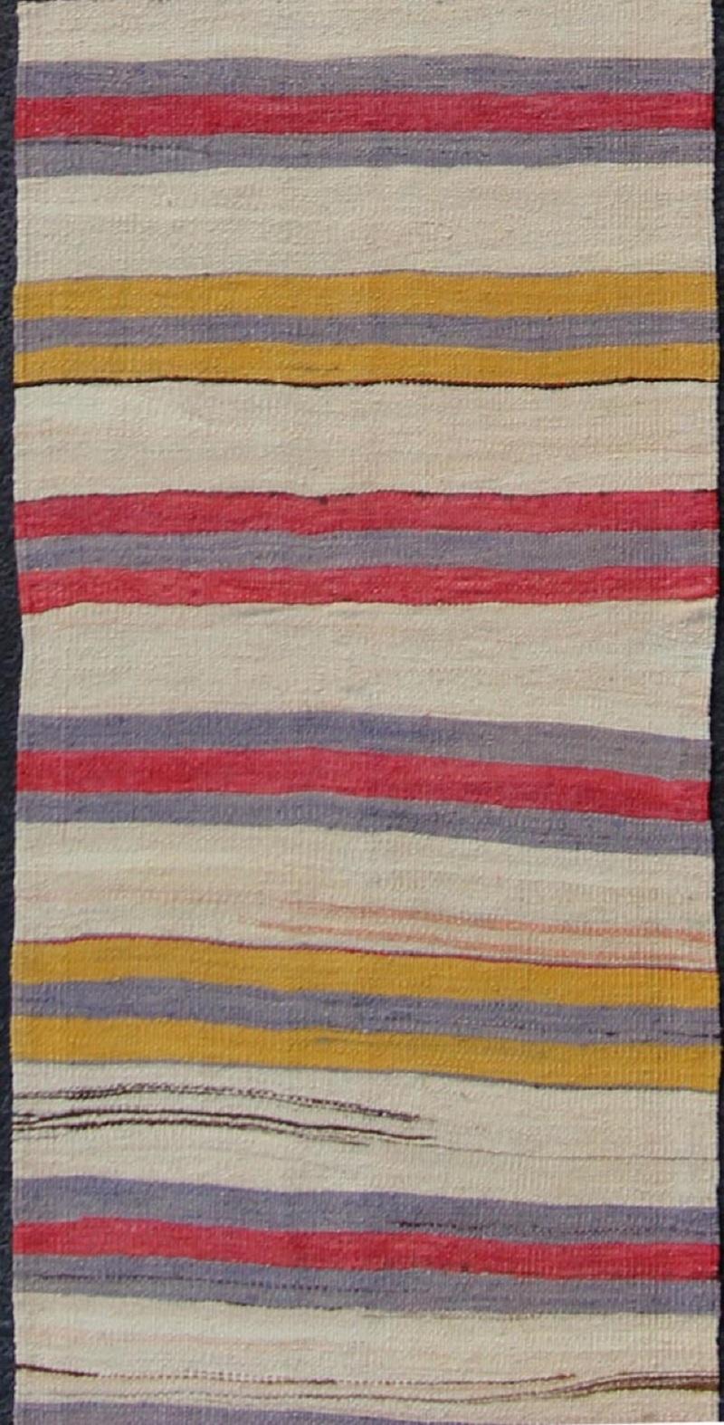 Yellow, red, ivory, and gray stripe design flat-weave vintage runner from Turkey, rug en-165311, country of origin / type: Iran / Kilim, circa 1950.

Featuring a dynamic stripe design, this unique 1950s Kilim runner showcases an array of vibrant