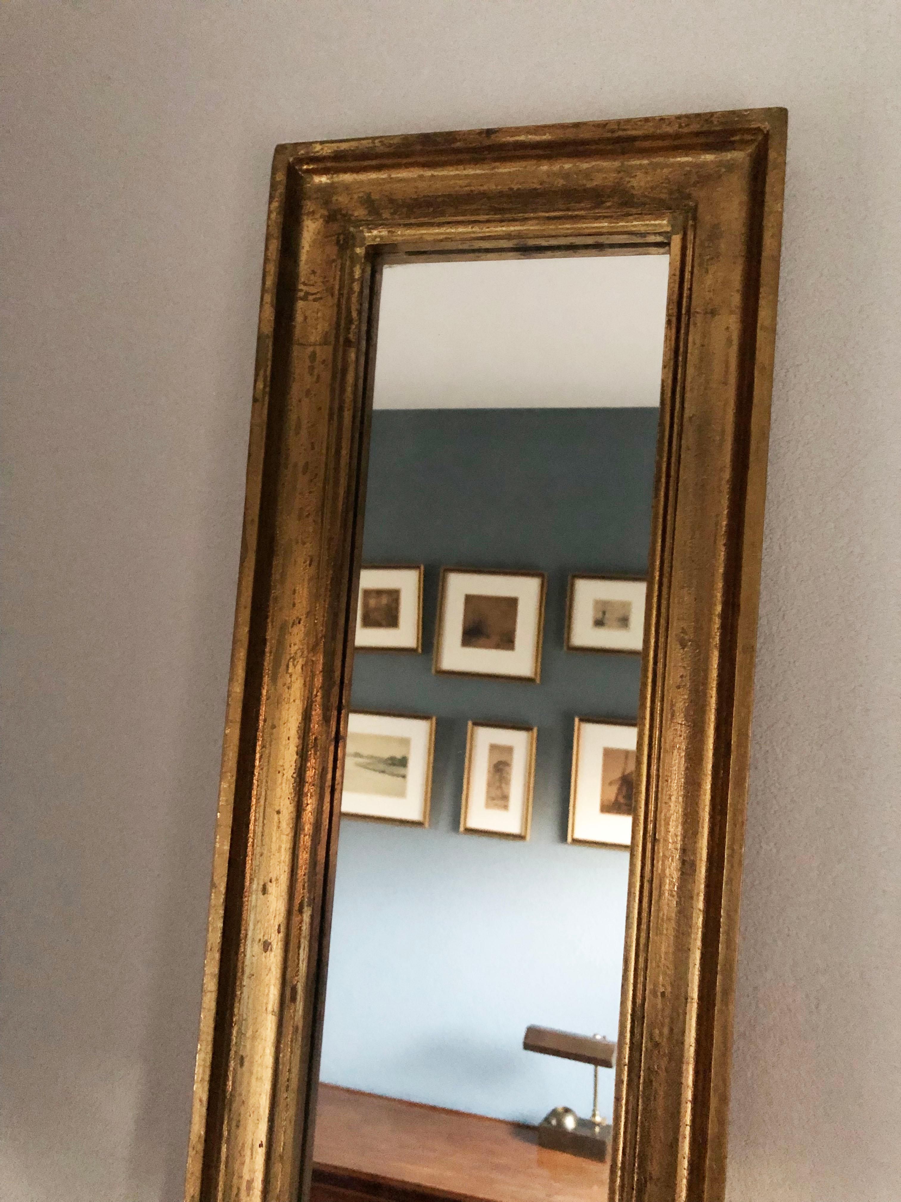 3 Very long (2 mtr) gilded full-length mirrors in good condition. The frame is nicely weathered, which gives it an older look. 2 mirrors are identical and 1 has a very small almost invisible adjustment in the edge. The mirrors have a hanging