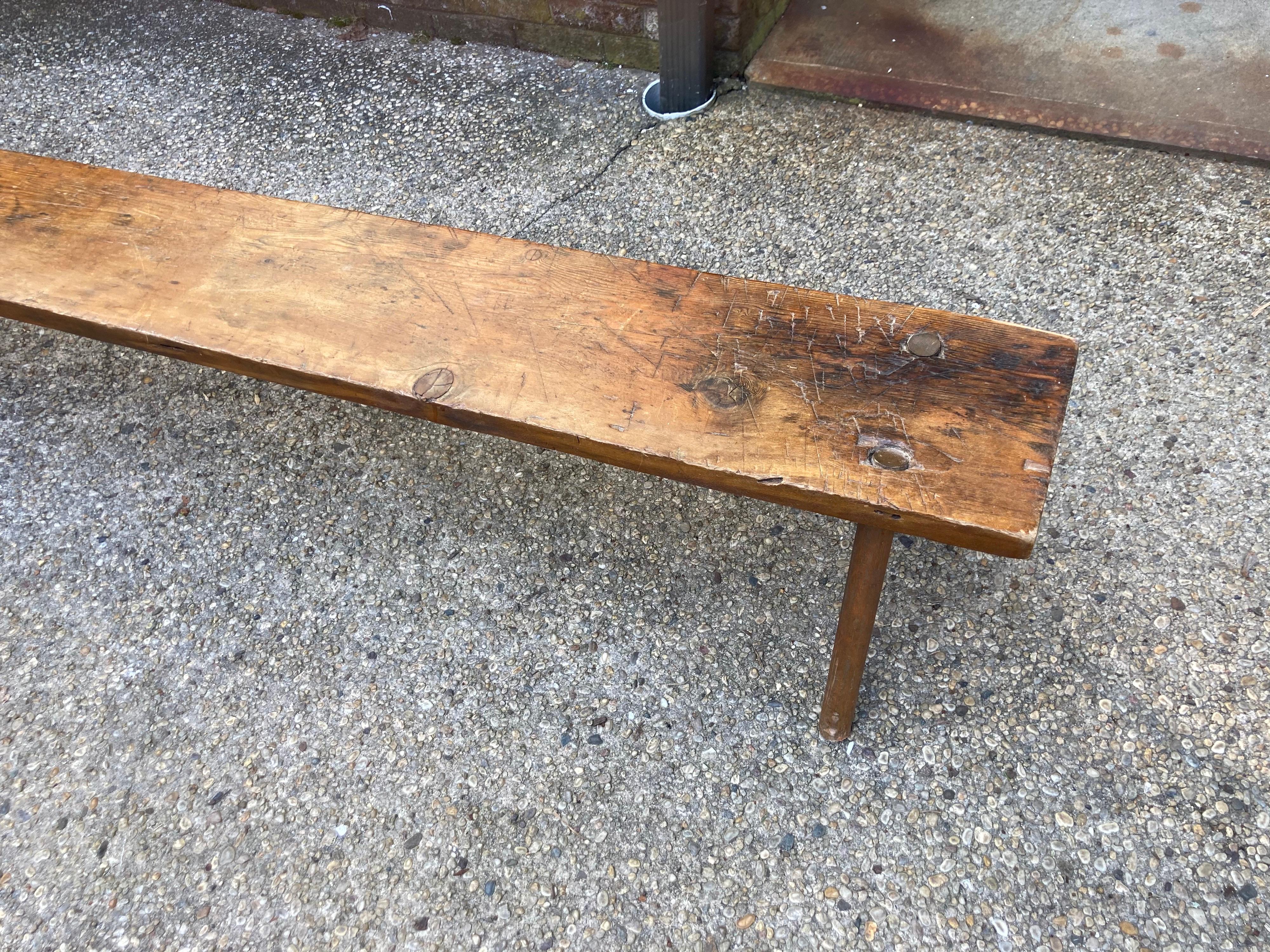 Hunt bench ..... long and bench with 4 legs, stretching 8.5' .... one-piece of wood.