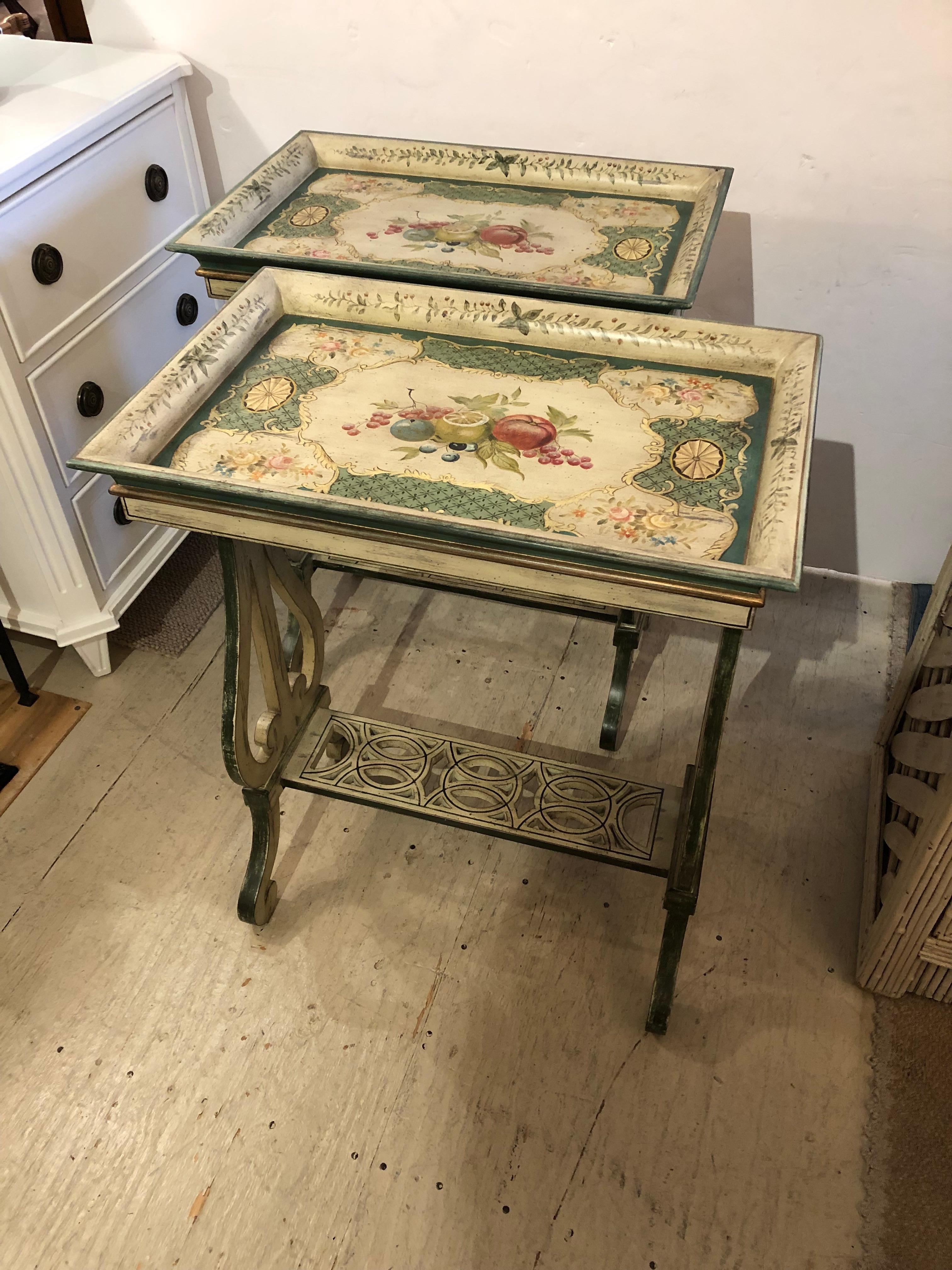 A matching pair of painted rectangular side tables having lyre shaped legs and fretwork lower tier. Color palette is a refreshing neutral blend of green, cream and pink.