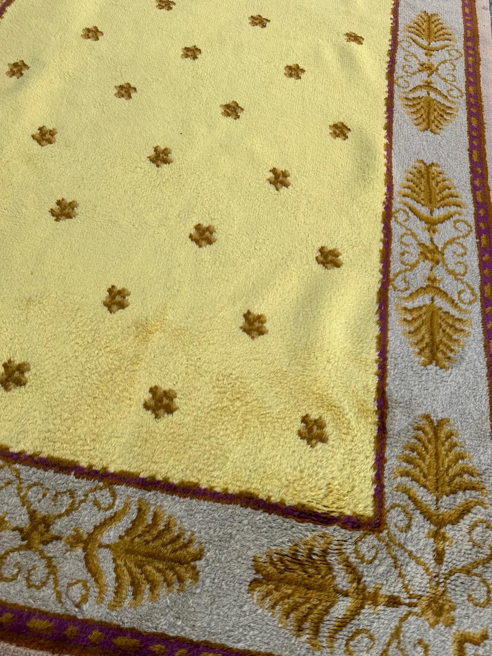 Presenting a regal masterpiece from the prestigious Aubusson manufacturing: an exquisite early 20th-century French Savonnerie rug. This royal treasure features intricate simple and luxurious designs in style of Louis XVI period, and a rich array of
