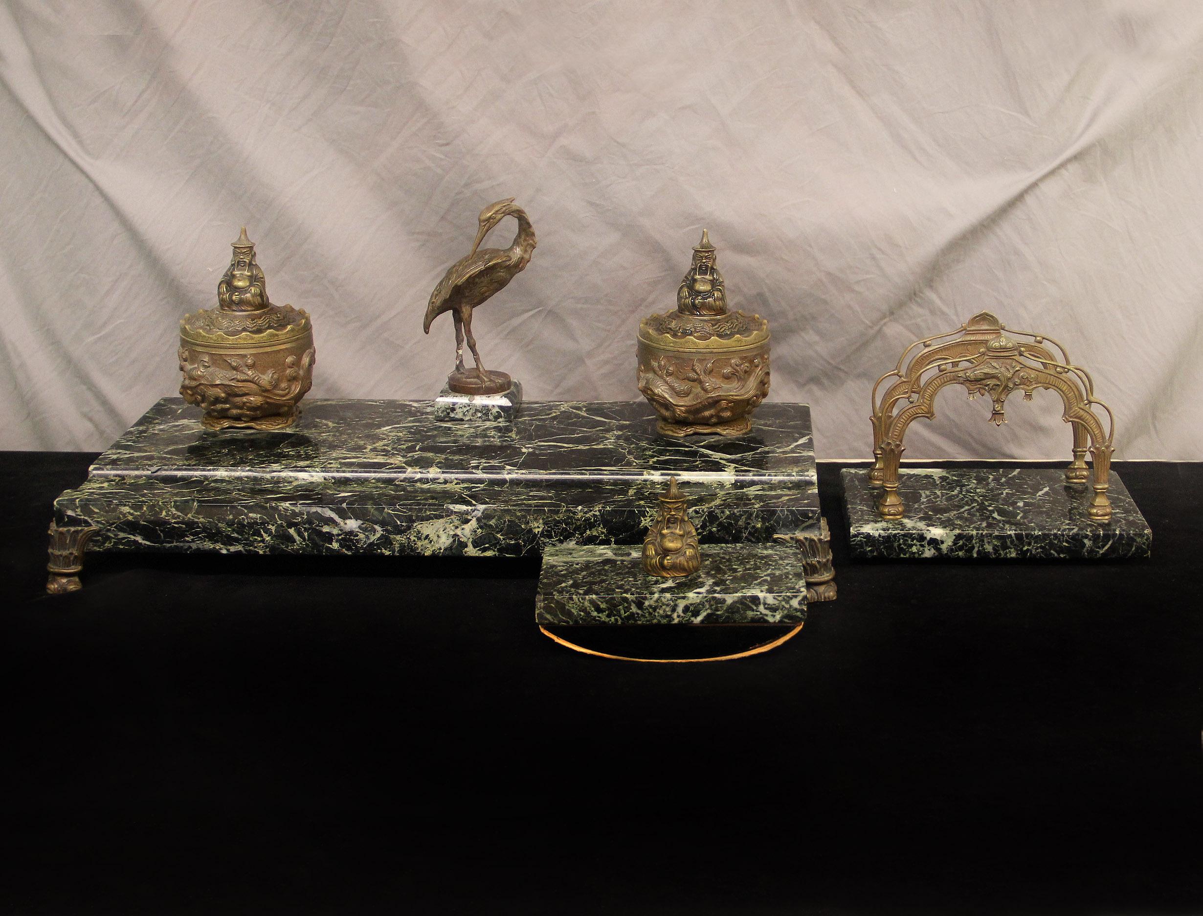 A very nice late 19th century bronze and marble 3 piece desk set.

The large Chinese designed rectangular desk set centered with a bronze crane and two decorated ink holders on either side, sitting on a green marble base and bronze feet, the set