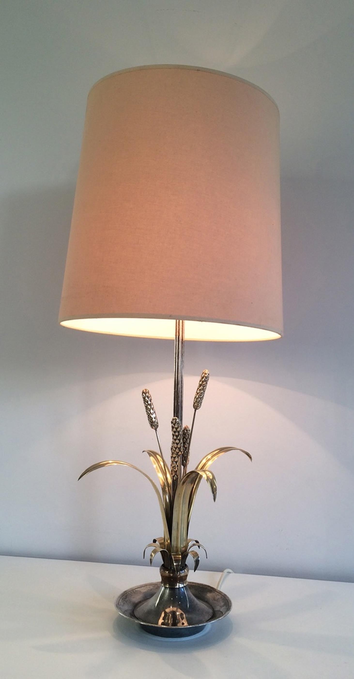 This very nice and decorative table lamp is made of silver with brass ears of wheat. This is a French work, circa 1940.