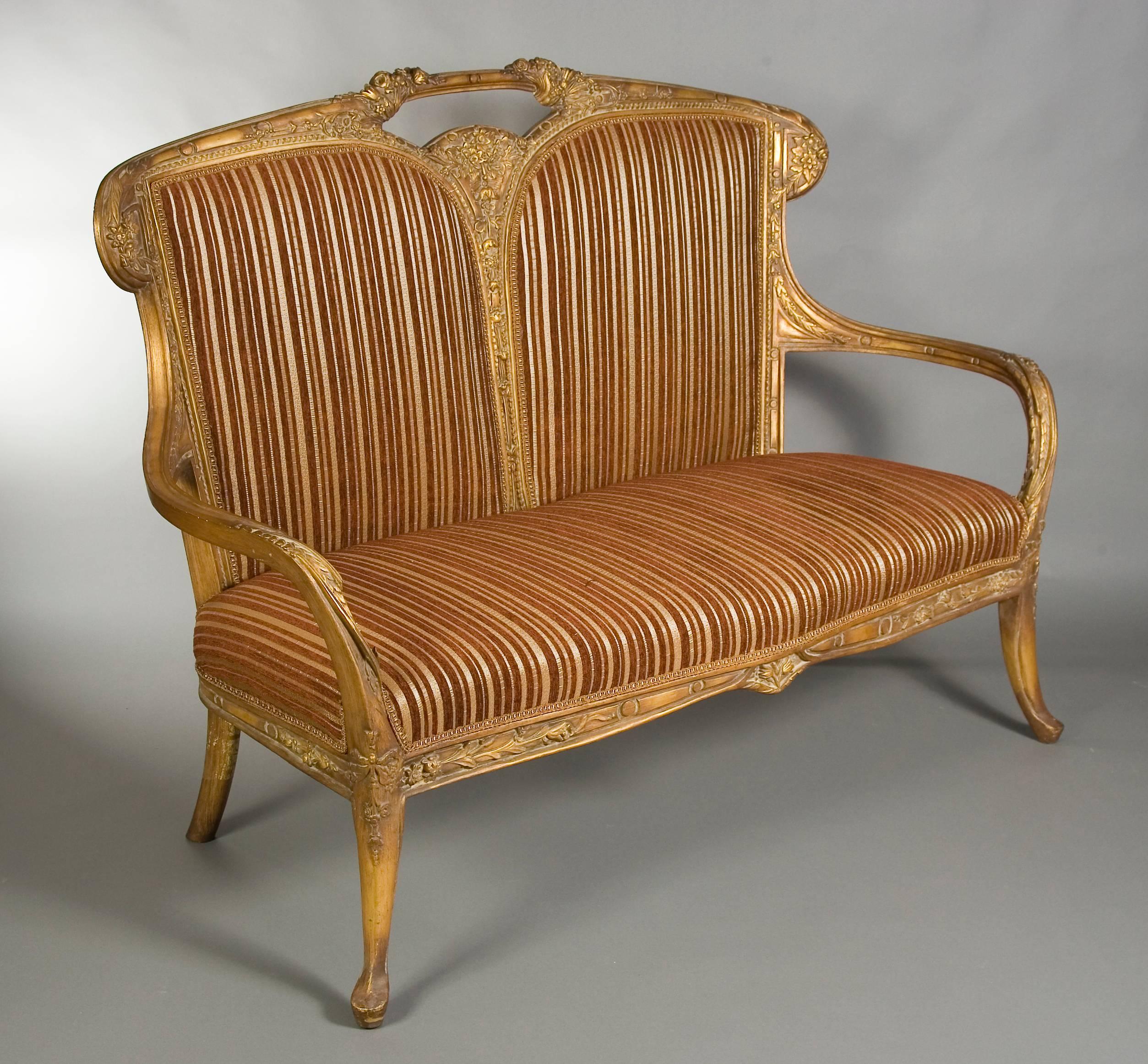 Solid beechwood with carvings. On slightly bent and twisted, shaped legs. Slightly carved and cambered frame. Both-sided armrests turned and profiled. The legs are slightly turned outwards and have beautiful wood carving. Curved backrest with middle