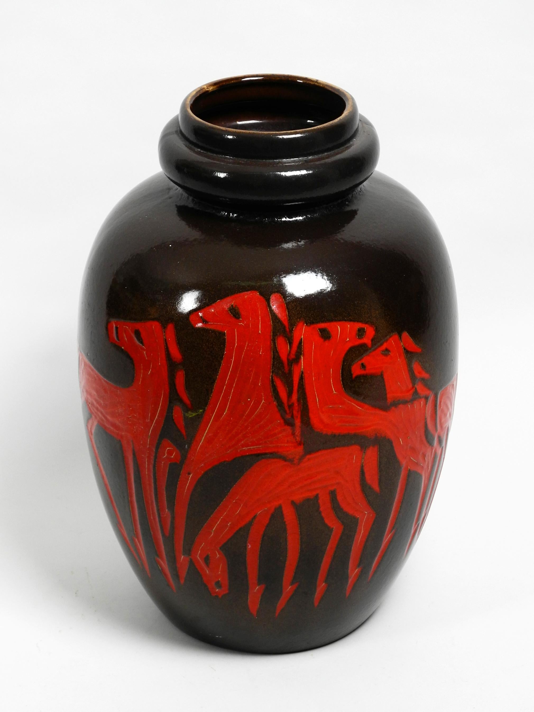 Very nice extra large dark brown ceramic floor vase with red abstract motif with horses. 
Nice high quality minimalistic design.
Very nice patina, the red color on the horses has got some Fine cracks over time. 
No damages to the entire vase. No