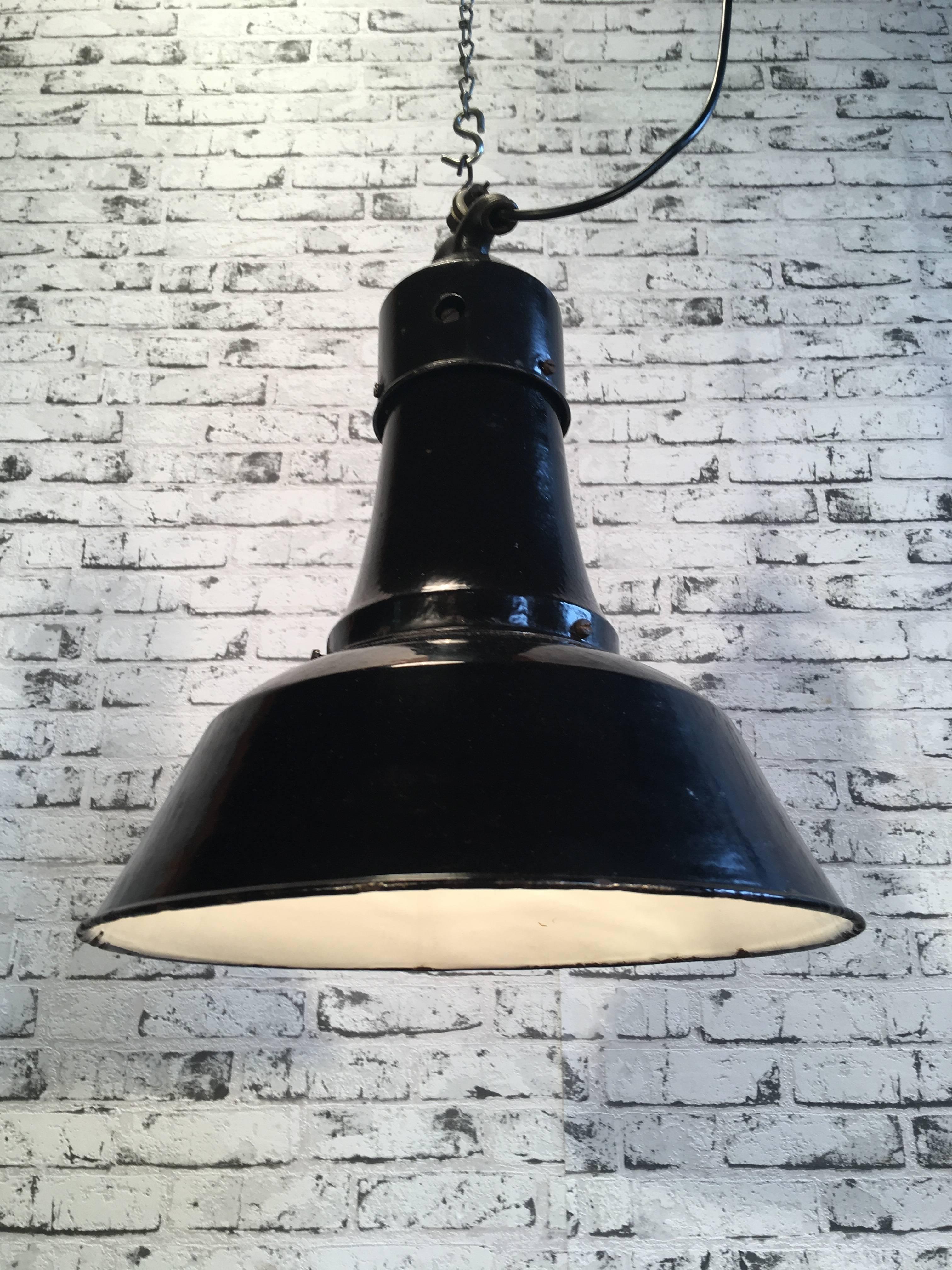 This rare very old industrial lamp comes from the 1925 factory. Lamp has black enamel exterior, white interior. Cast iron top. New porcelain socket E 27 and wire. Weight 2.5 kg.
