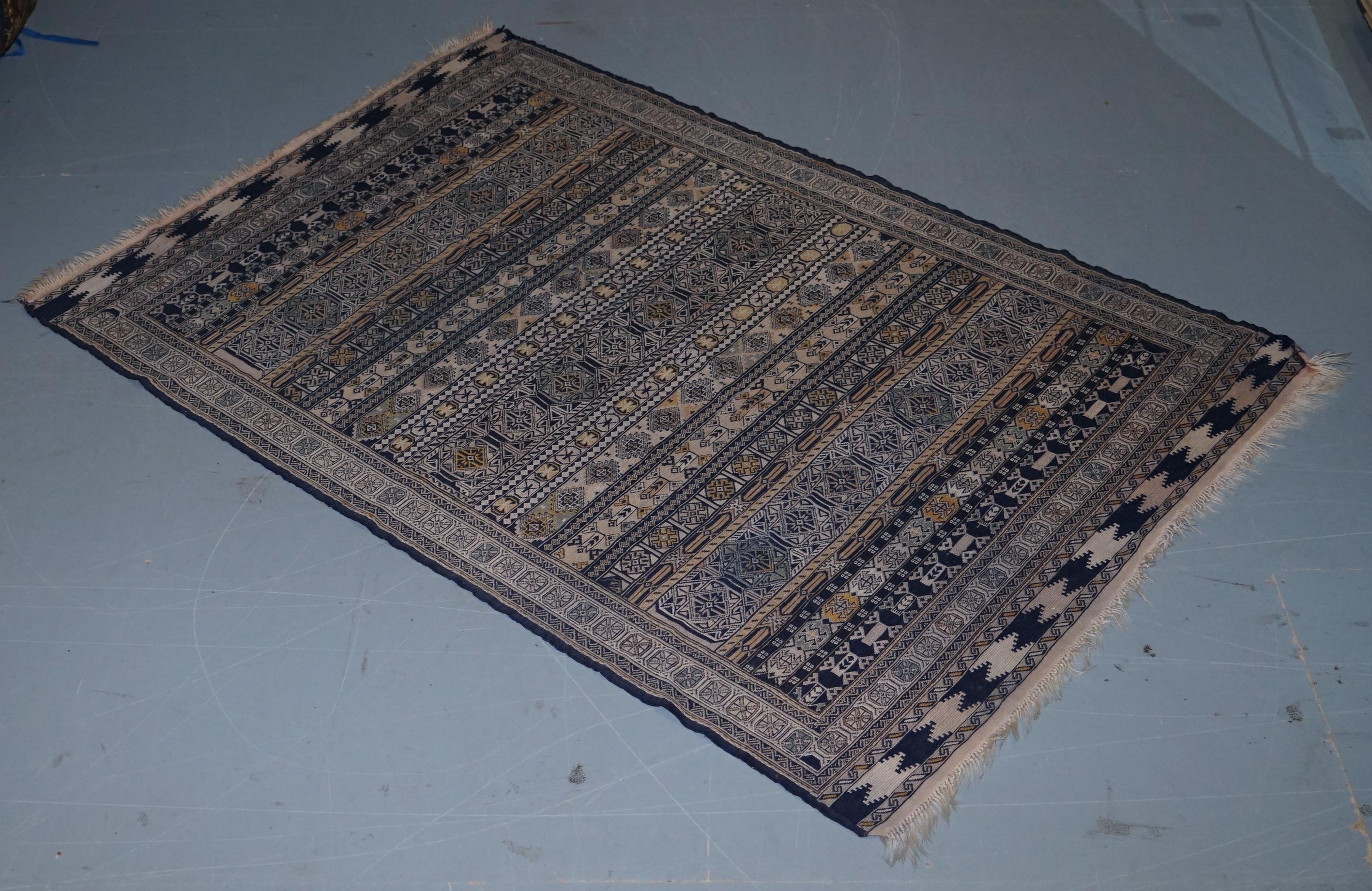 We are delighted to offer for sale this original 19th century hand woven and knotted kilim rug

The one is a medium kilim, its mostly blues and is a 19th century hand knotted and woven example, have a look at the picture of the back of the rug and