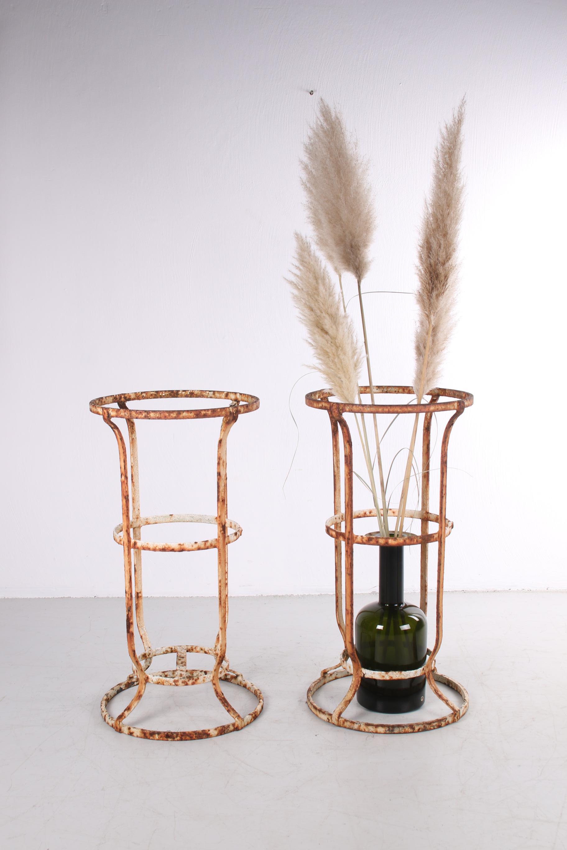 Very old wrought iron French garden stand a set of 2 with beautiful patina Dates from around 1900s.

This set comes from the South of France once bought at an antique fair. The patina is beautifully blended together with the cream/white original