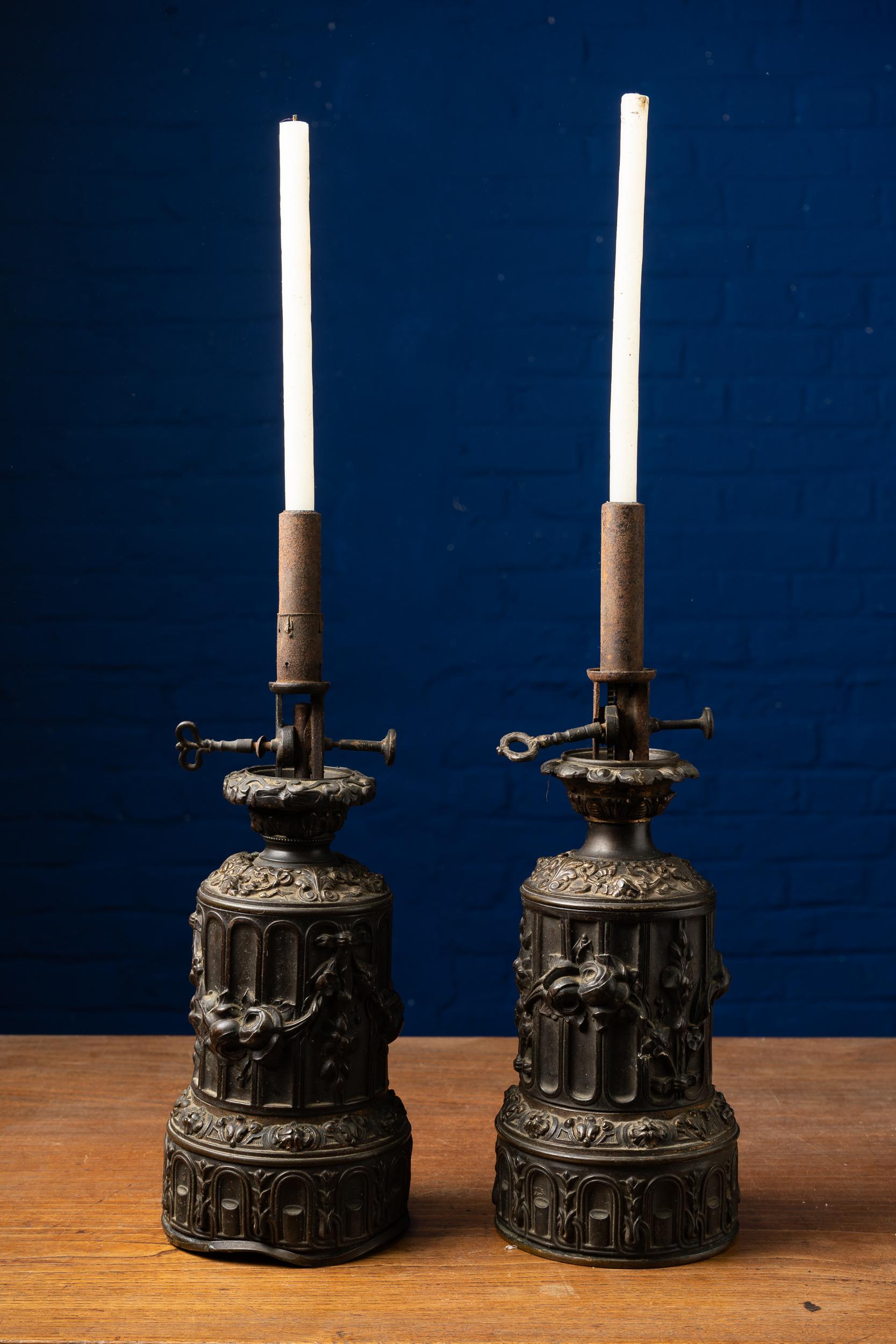 Unique ornate pair of copper alloy candleholders with moulded ribbons, foliage and floral features. The items are tagged on the bottom: Becatiltre Breveté.