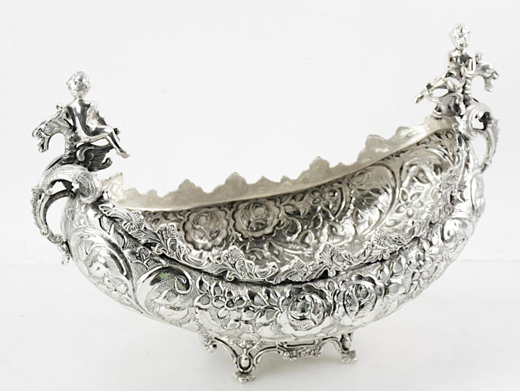 Elevate your dining or decor with this meticulously handcrafted Silver Plated Mid-20th Century Austrian Crescent-Shaped Footed Tableware Centerpiece. This exquisite piece exudes elegance and opulence. The centerpiece boasts an intricate and ornate