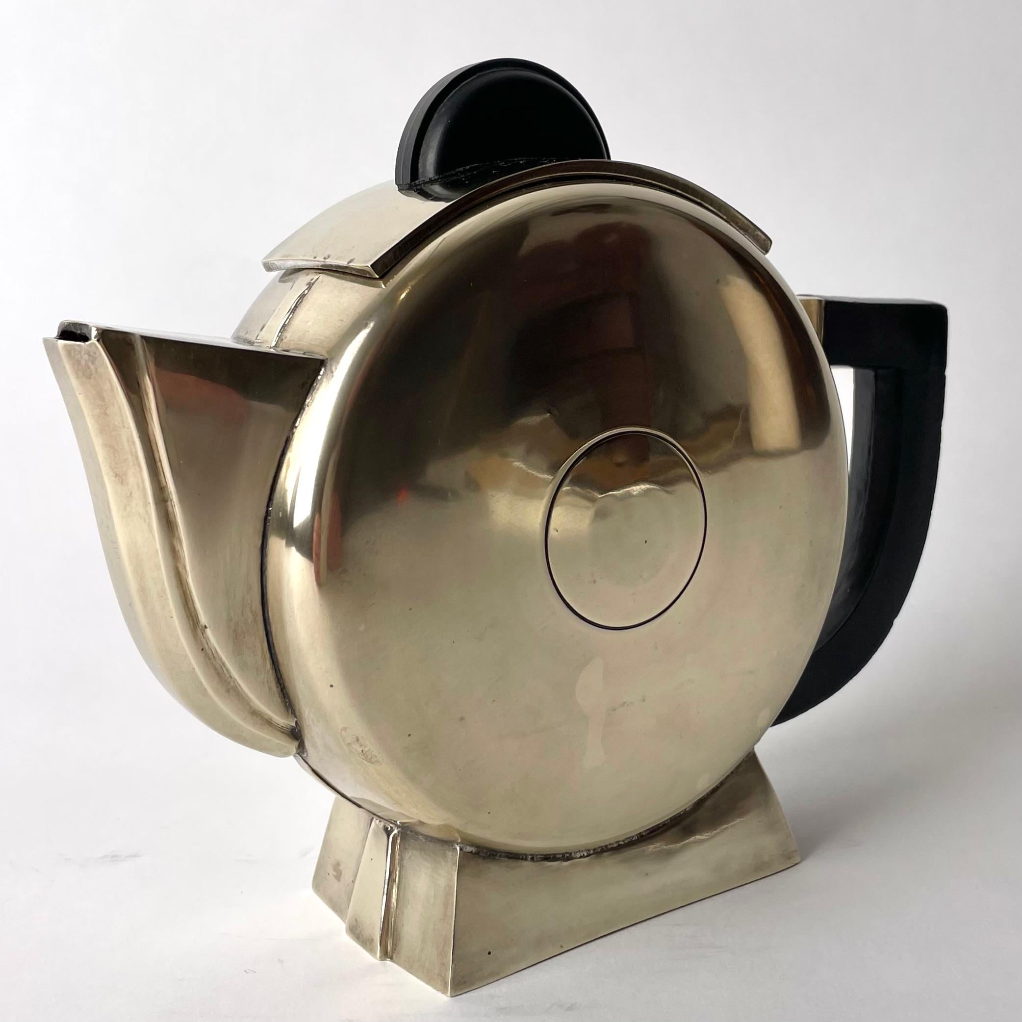 Very period Coffee Pot in extreme Art Deco, from the 1920s - 1930s. Made in  silver-plated white metal and with bakelite handles.

Wear consistent with age and use 