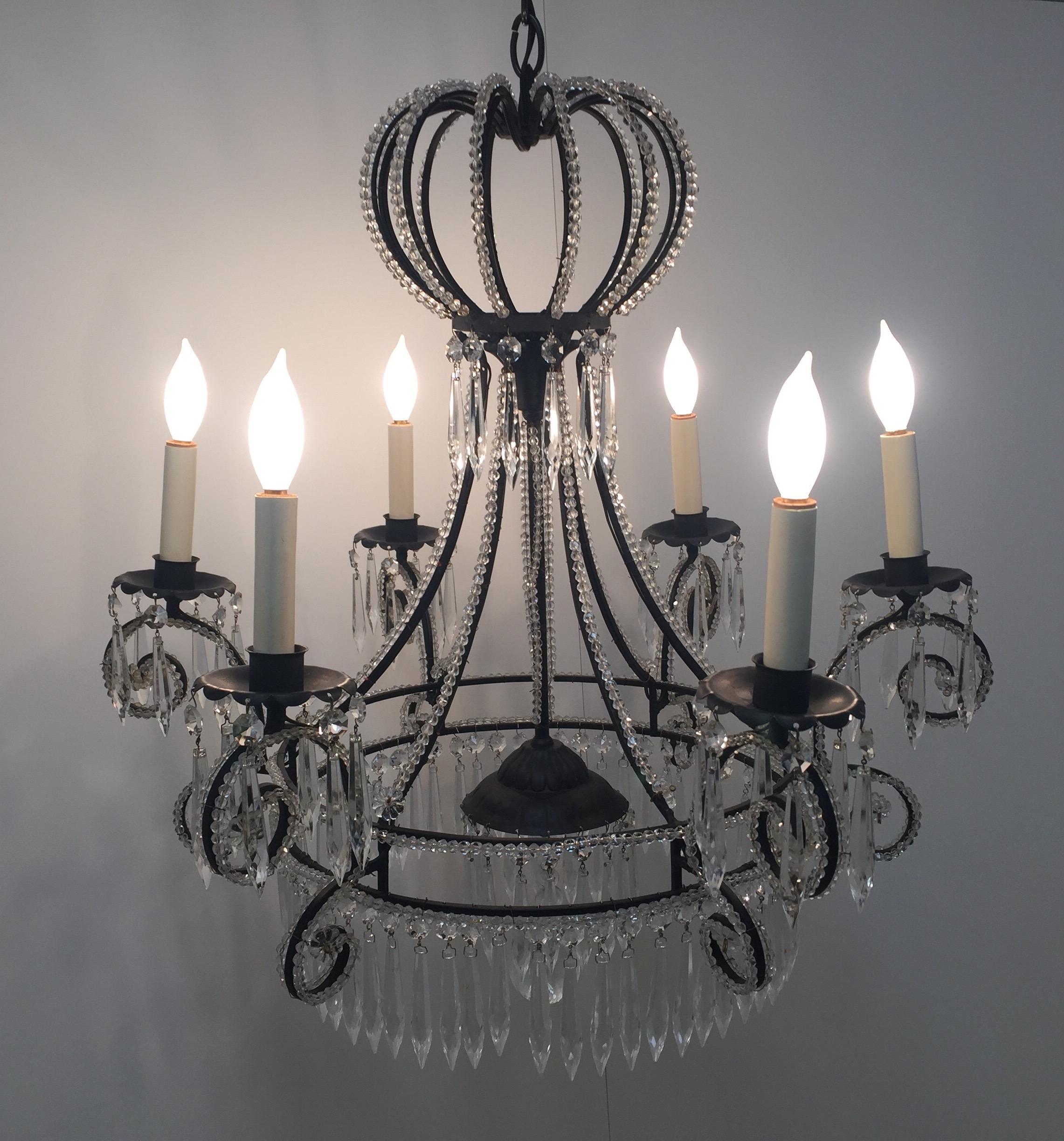 Wonderfully shaped French chandelier having black metal frame adorned with crystal beading, a crown shaped top, 6 arms, and 
artful placement of dripping crystals.
 