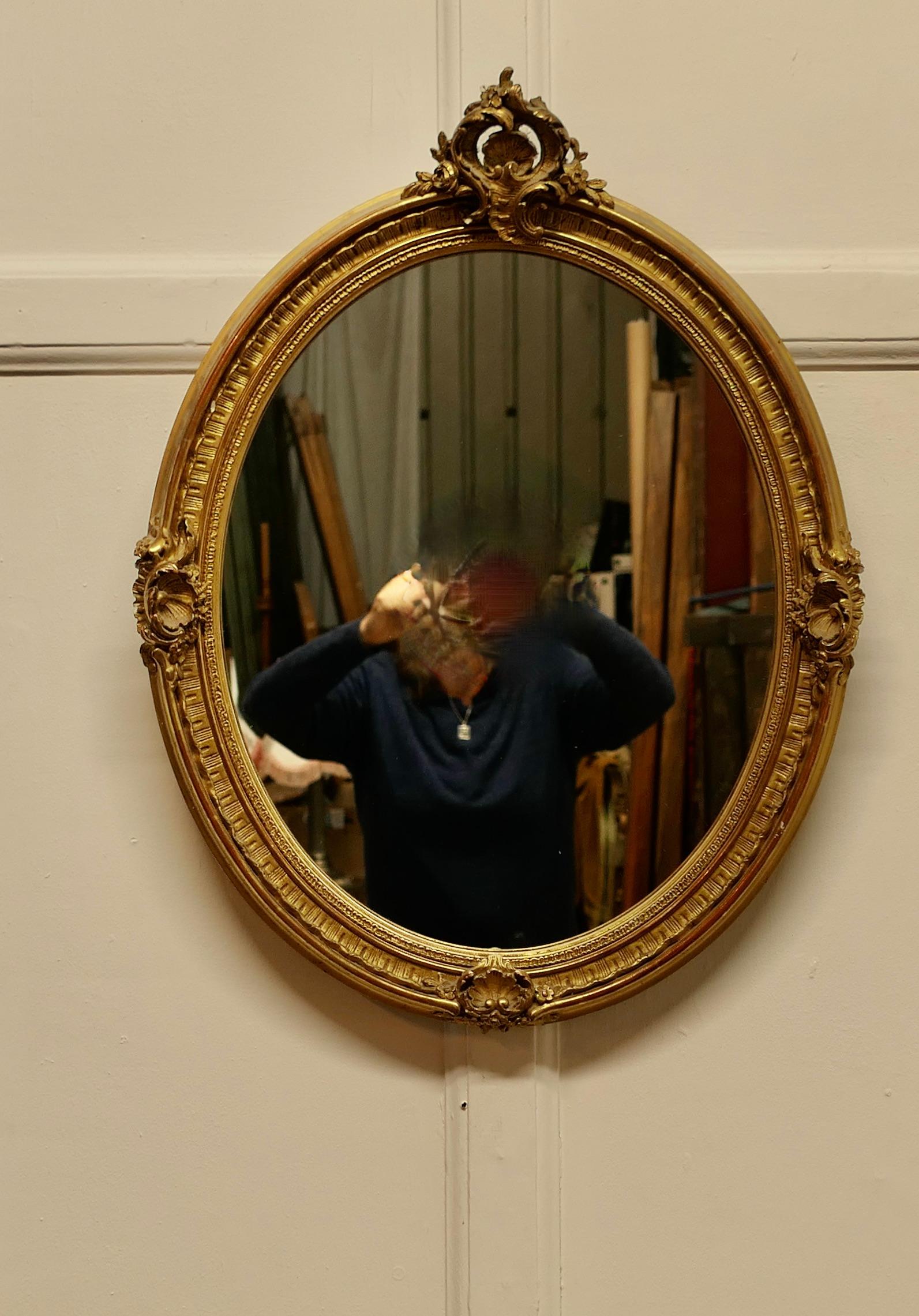 Very Pretty French Rococo Oval Gilt Wall Mirror

The Mirror has an exquisite 3” wide gilt Frame with Gold leaf in the Rococo Style, it is delicately decorated with Shells, Swags and Leaves and it has a lace frill border
The Oval frame is made in