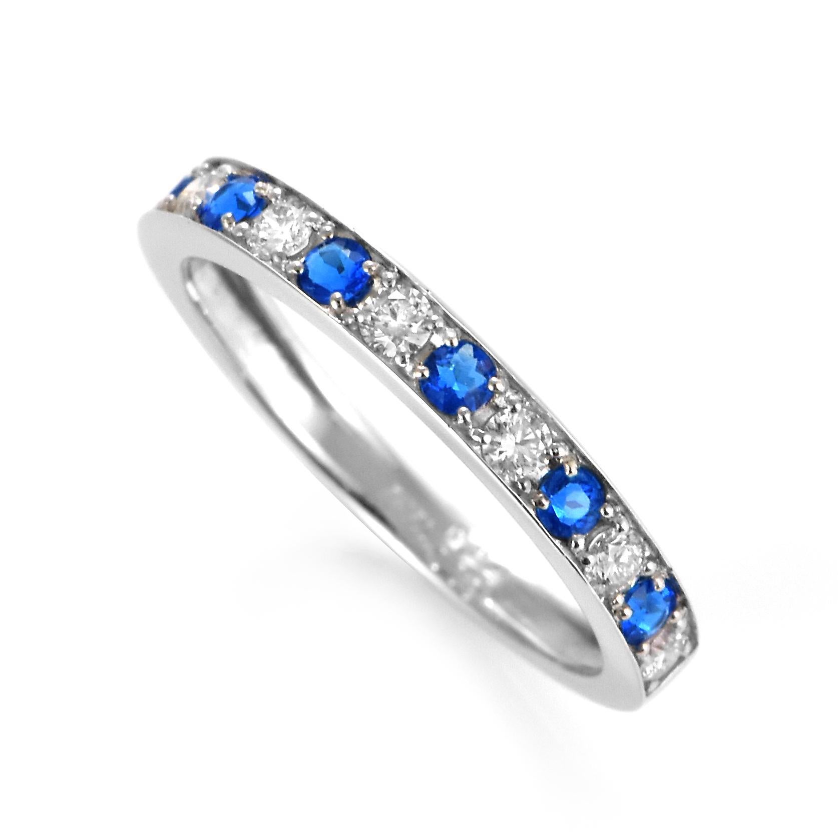 A stunning eternity Ring featuring a 0.18 Carat Hauynite/Hauyne and 0.24 Carats of Diamond Accents set in Platinum. Hauynite is an extremely rare mineral and even rarer gemstone. Its bright blue color is common for this gemstone, but is can be also