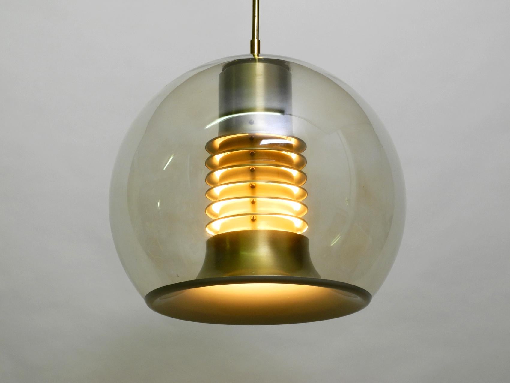 Very rare 1960s large glass globe Space Age ceiling lamp by Erco. Great space design for pleasant glare-free light downwards and to the sides. Shade is made of thick glass in light brass color. The frame inside is made of brass anodised