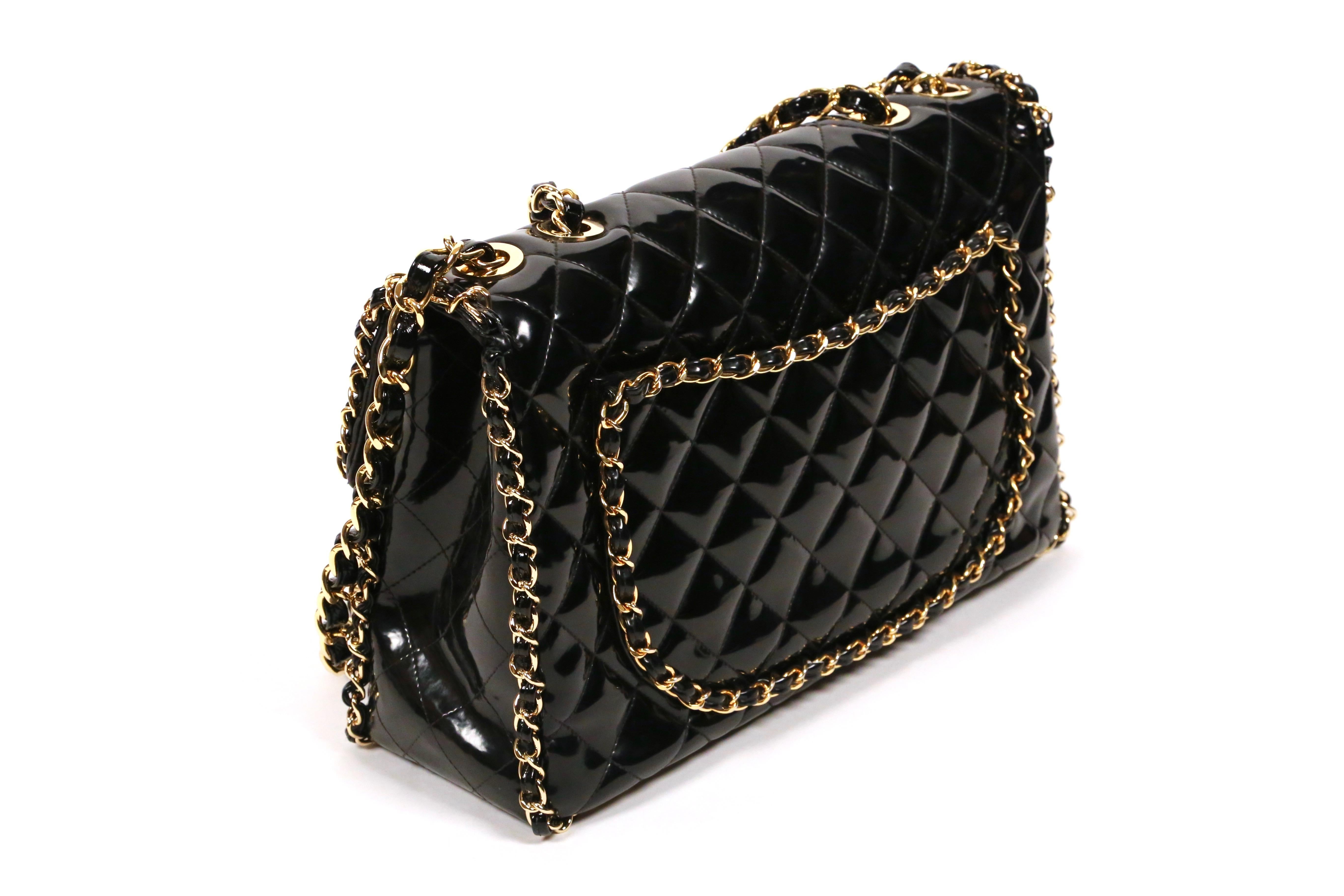 Very rare, jet-black, patent leather jumbo maxi bag with gilt chain trim dating to the 1990's designed by Karl Lagerfeld for Chanel. Approximate measurements: height 10”, width 14” and depth 4.5”. Chain (double strap) has a 13